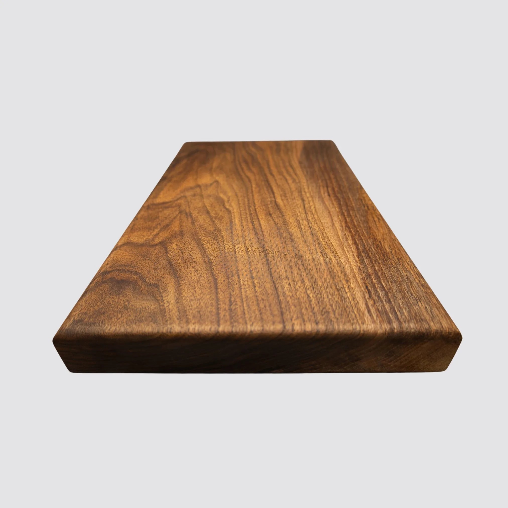 Handcrafted sustainable walnut chopping board featuring rich natural grain patterns