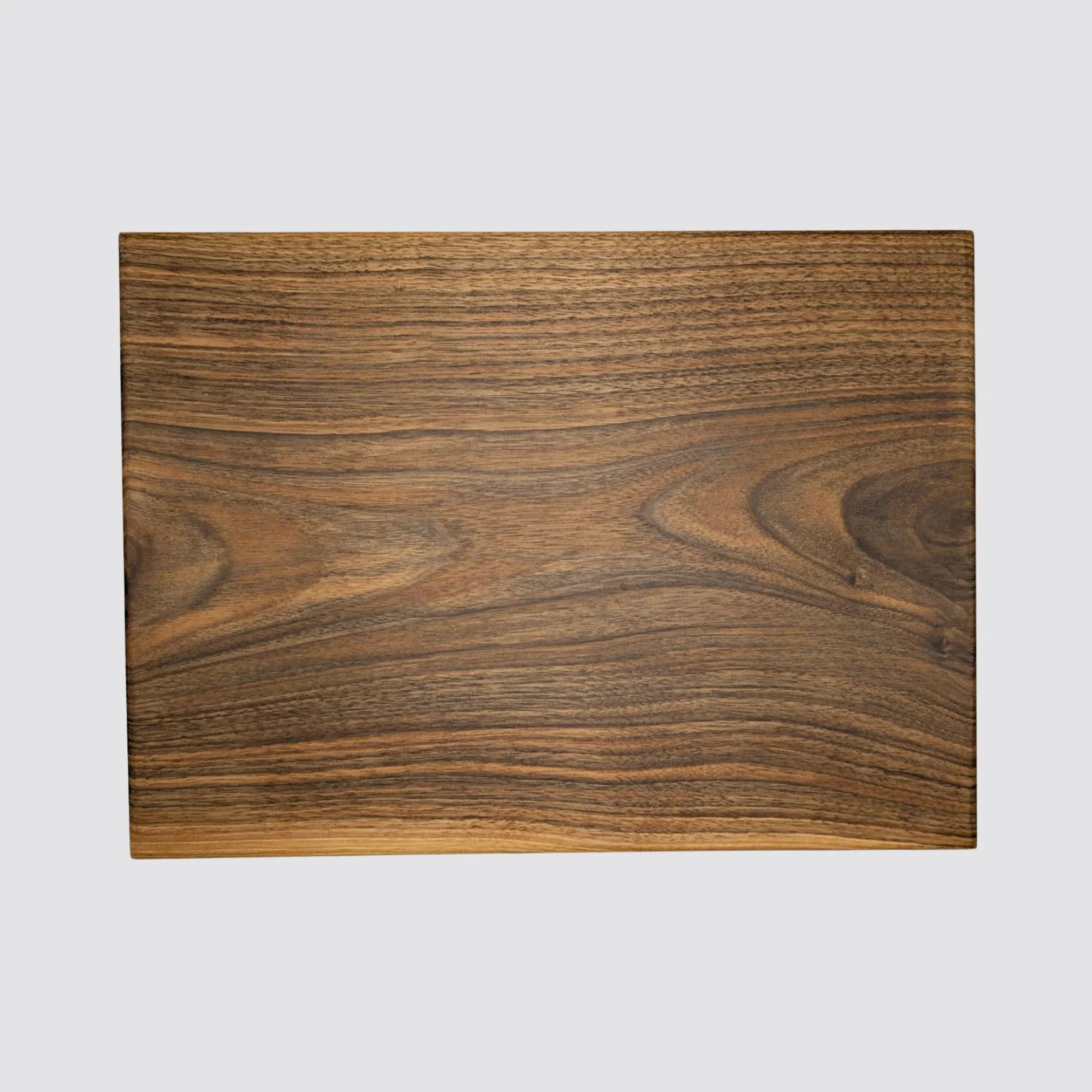 Large walnut wood chopping and cutting board, showcasing natural grain patterns and smooth finish