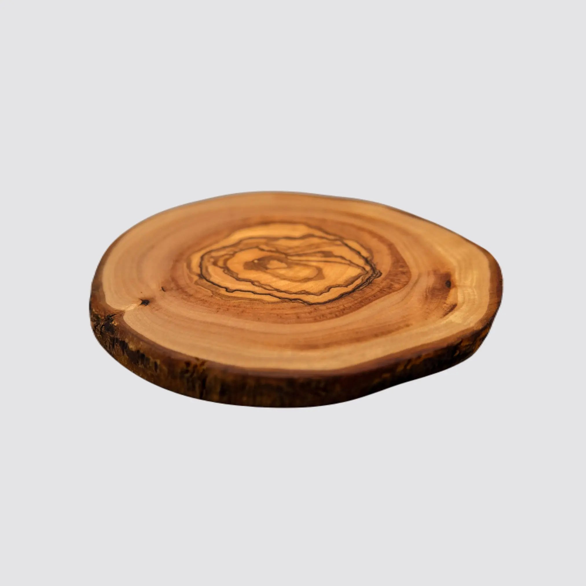 Artisanal olive wood coaster with rustic charm and eco-friendly design.