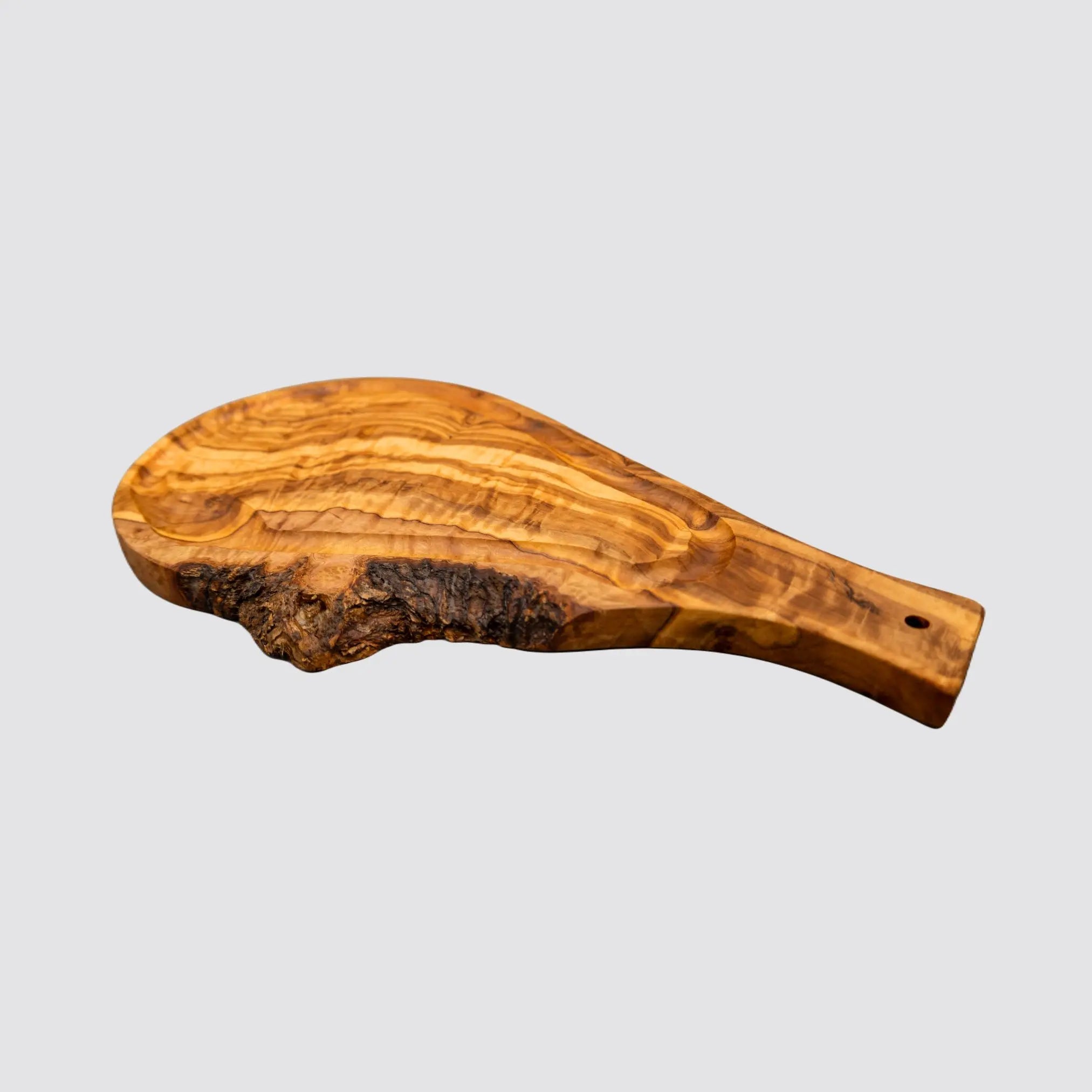 Artisanal olive wood steak board with juice groove for neat meal prep.