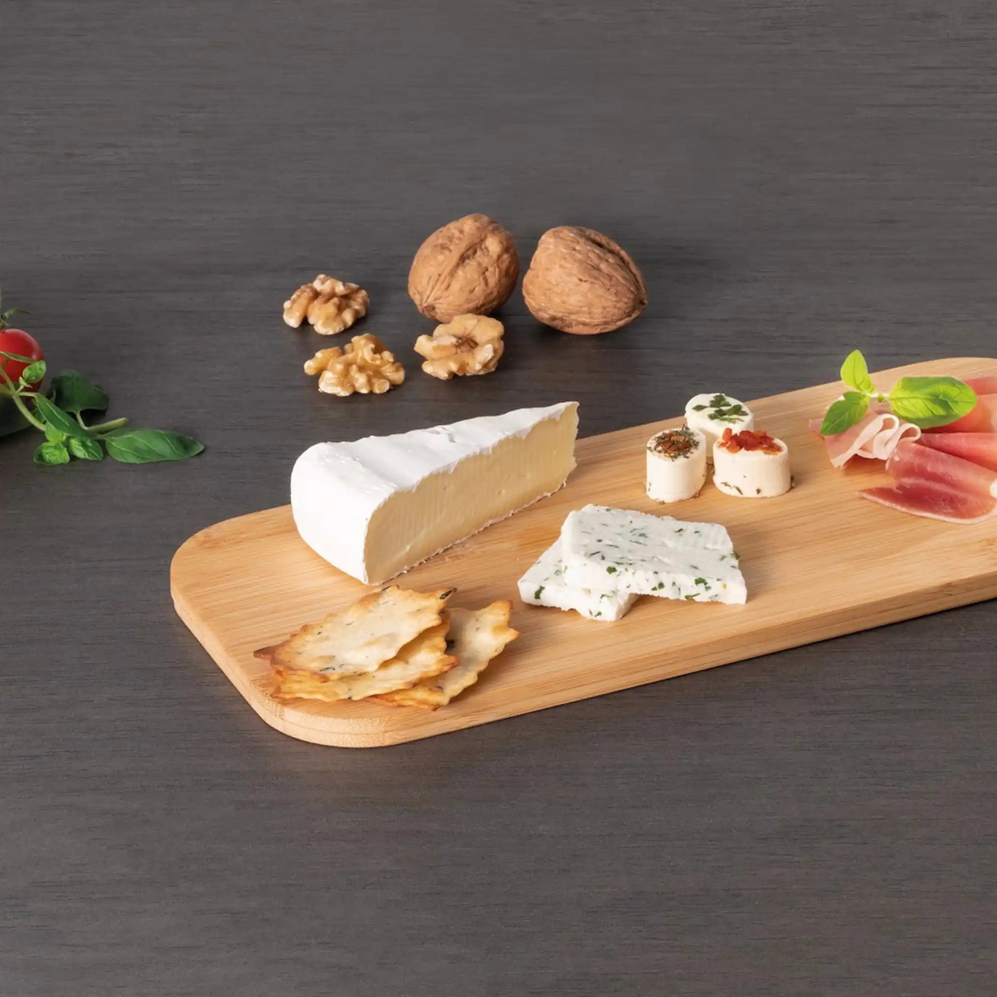 Bamboo serving board styled with charcuterie and cheese, featuring an assortment of cheeses, cured meats, olives, and rustic bread, highlighting its natural finish and eco-friendly design.