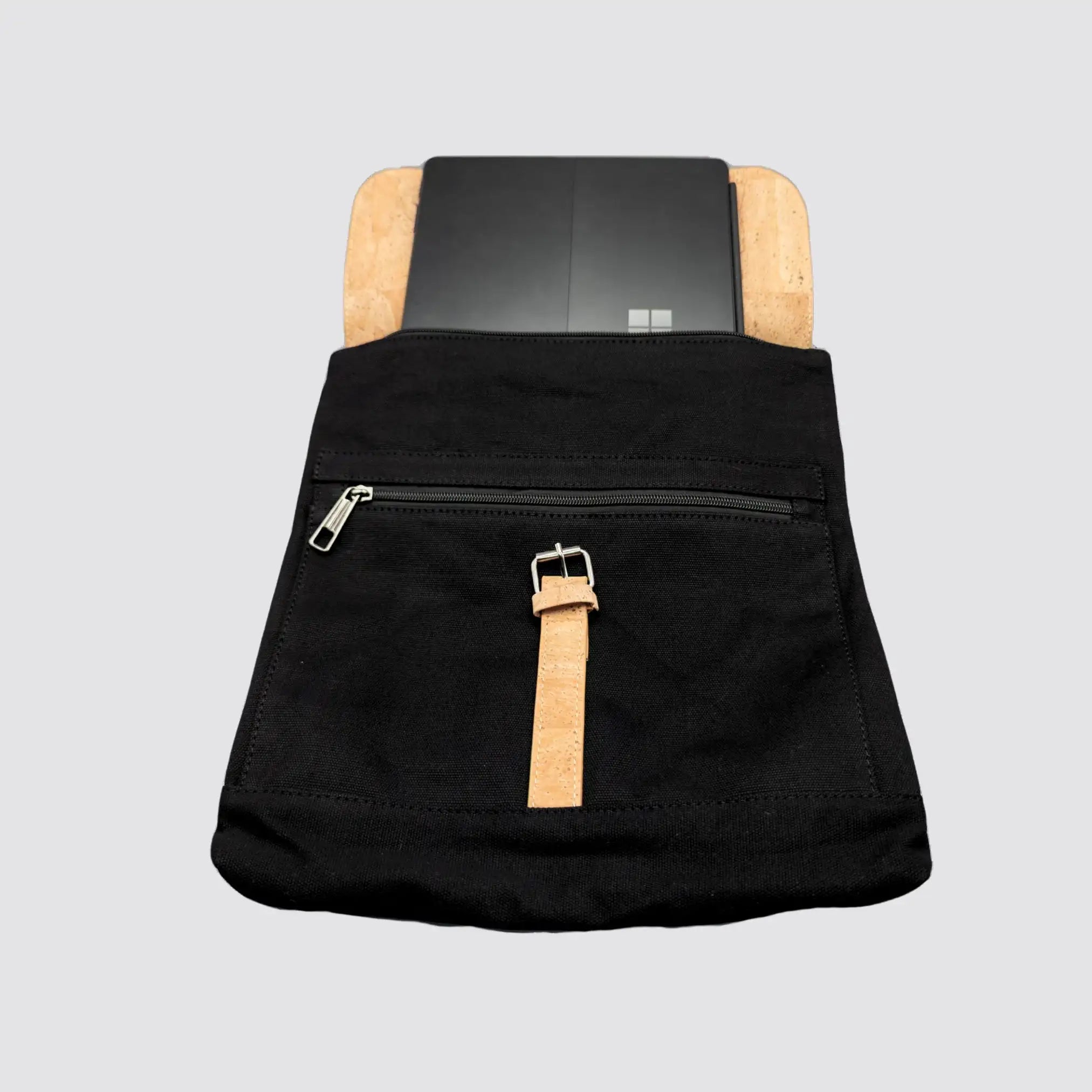 Black cork laptop backpack featuring a flap closure with a cork buckle.