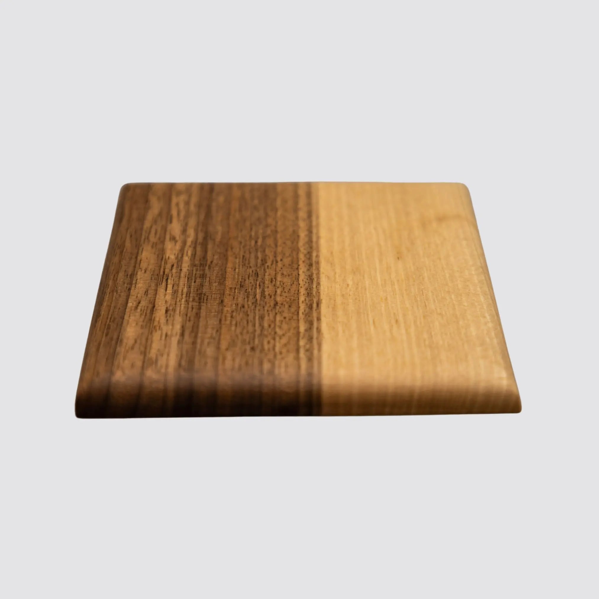 Close-up of a walnut coaster detailing the intricate natural wood grain and polished surface.