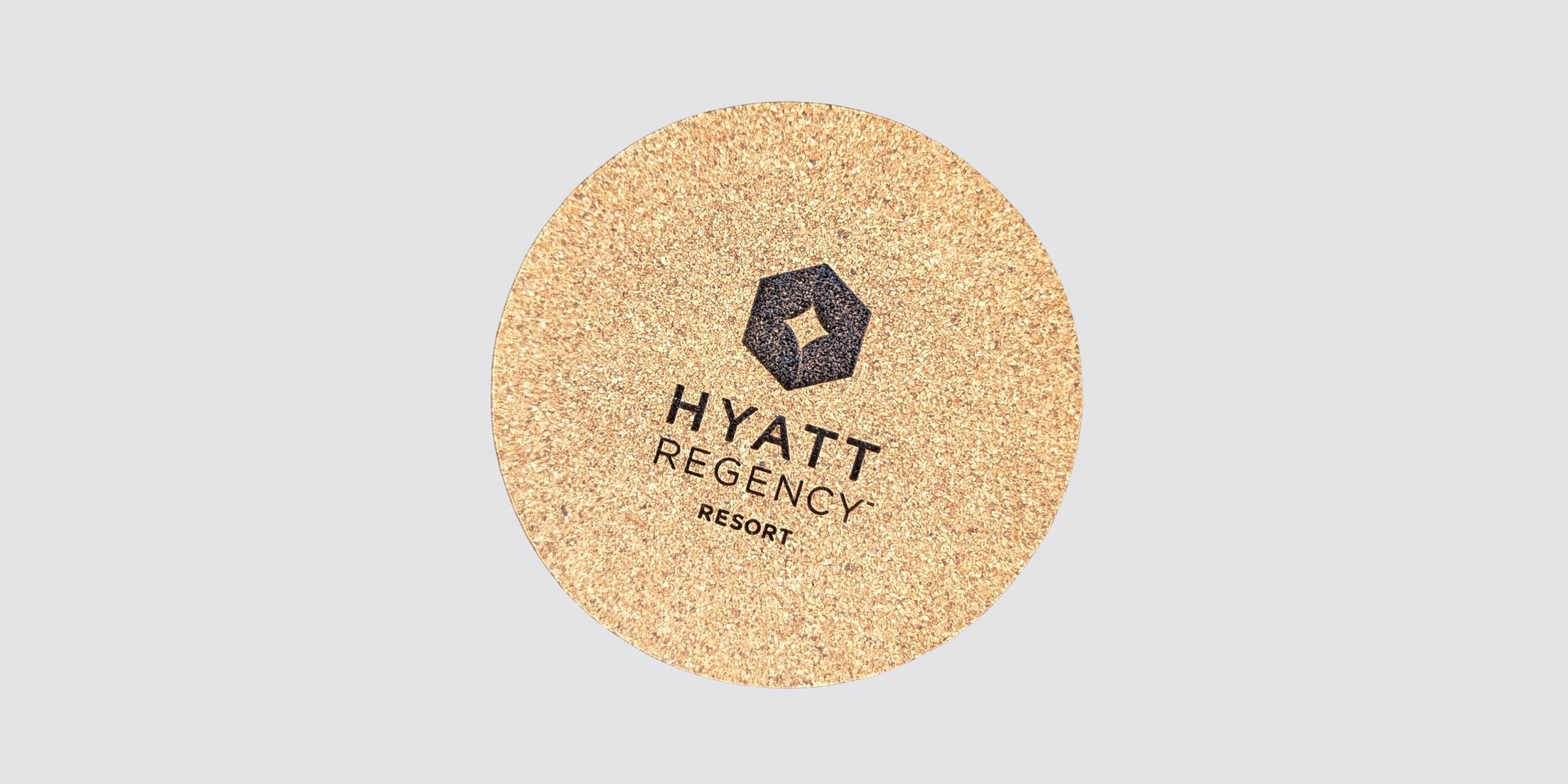 cork coaster engraved with Hyatt Regency hotel logo
