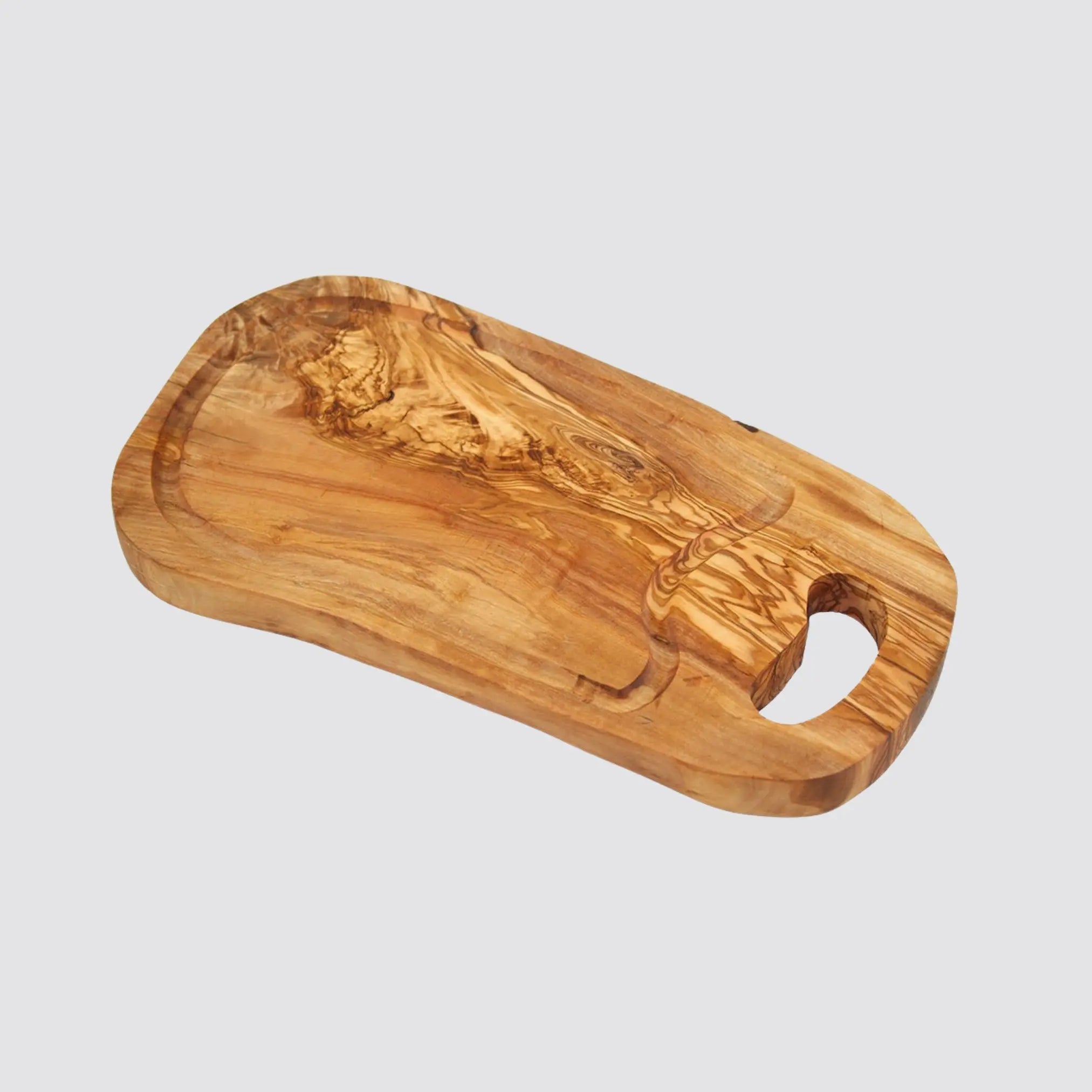 Durable olive wood cutting board with groove for catching liquids.