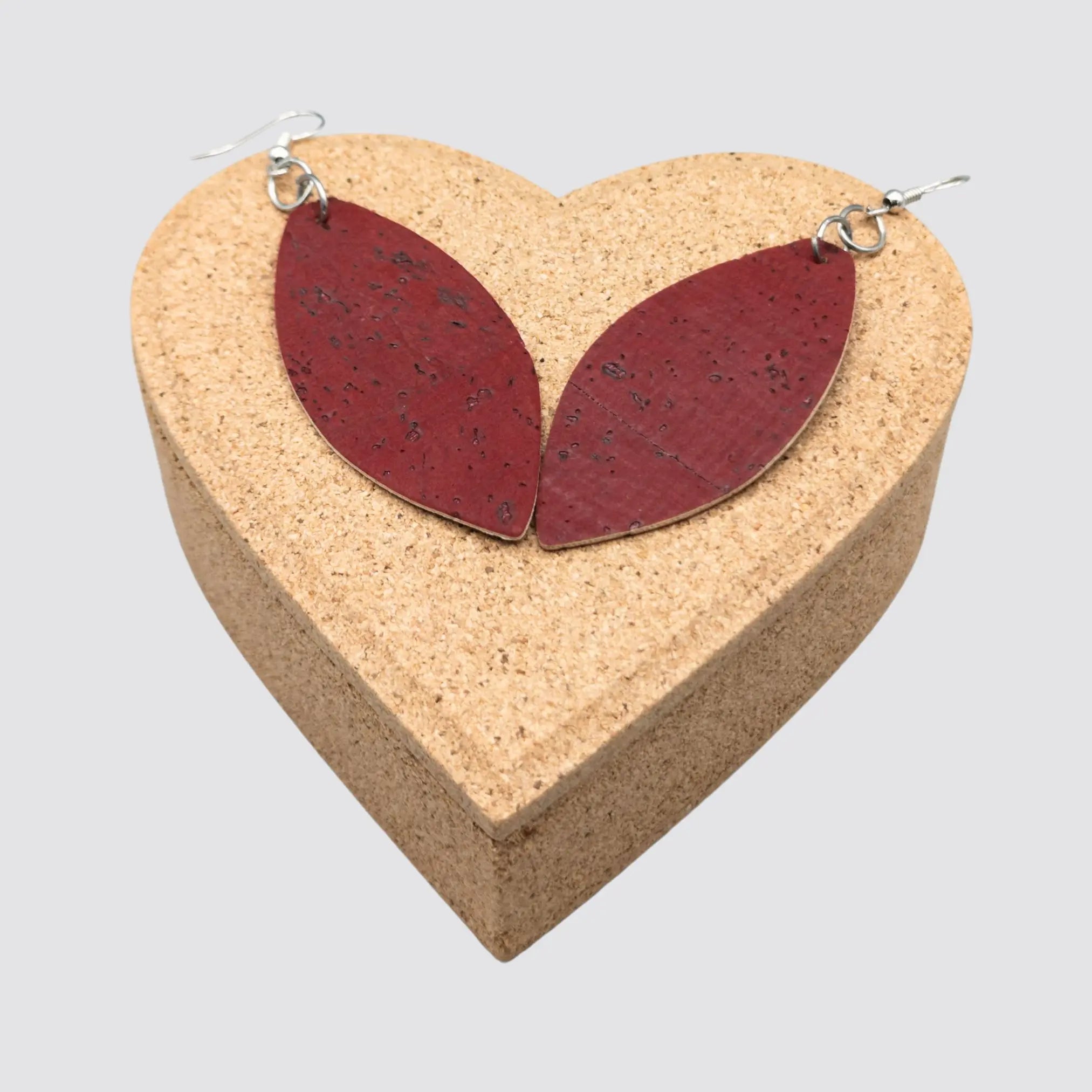 The elegant cork earrings are displayed on top of a heart-shaped gift box.