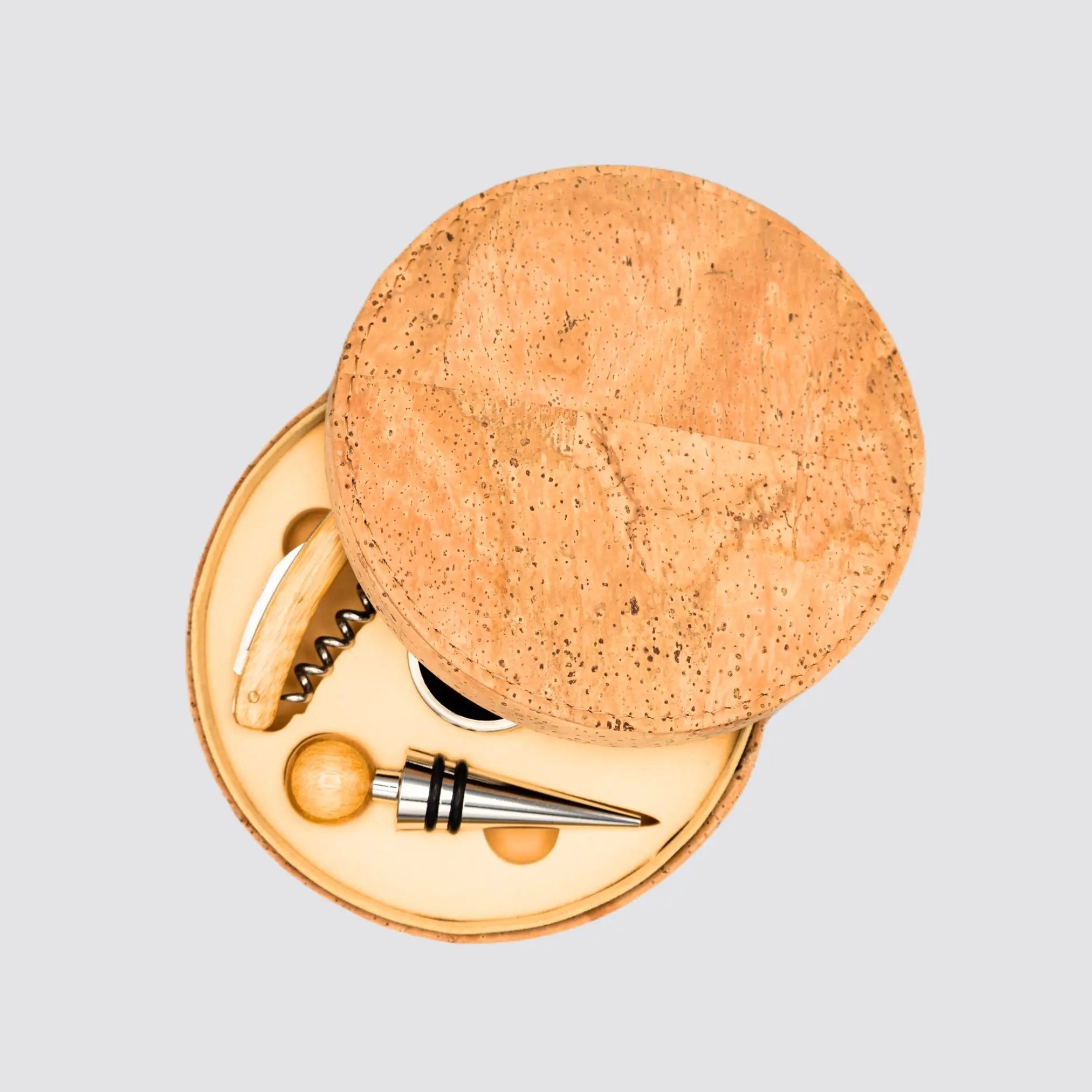 Elegant wine accessory set with an opener, pourer, drip ring, and stopper.