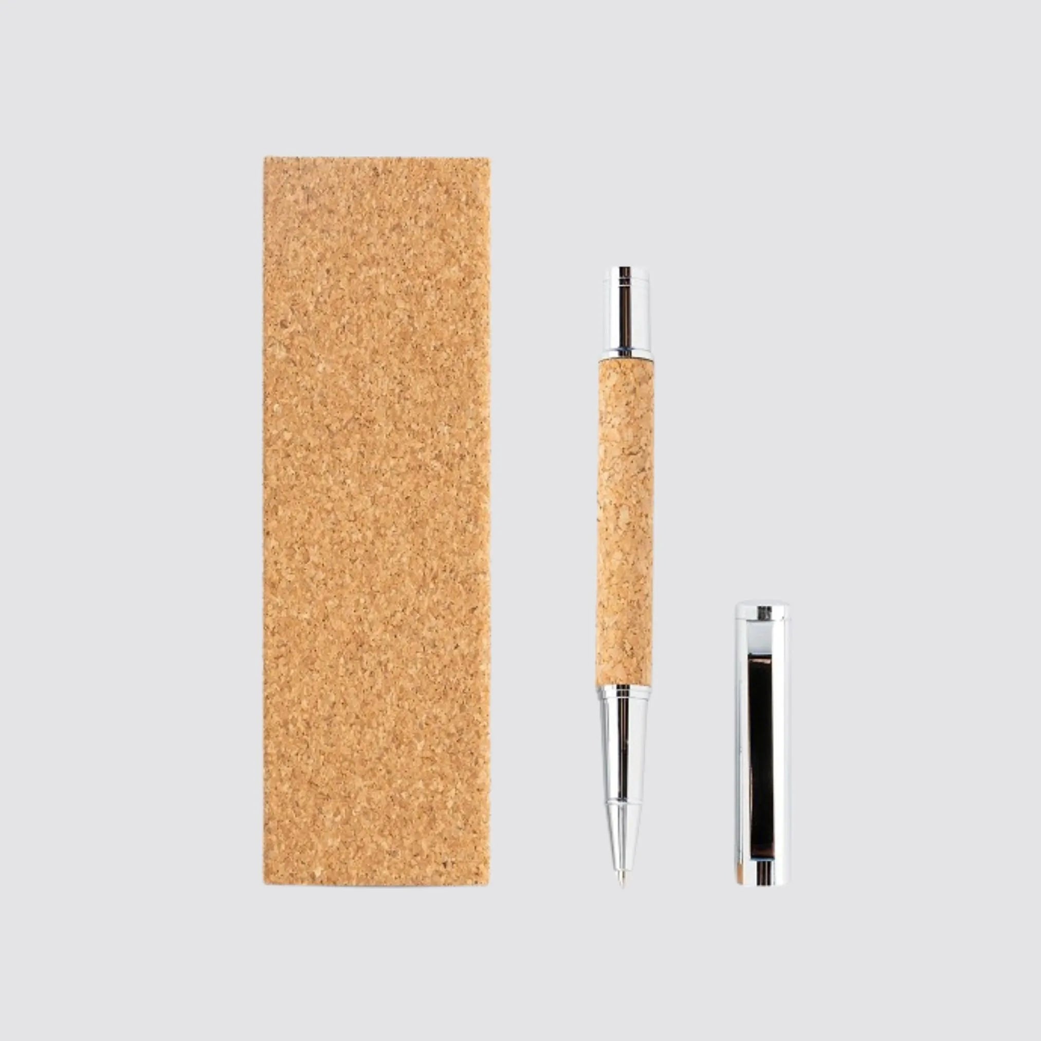 Flat lay of a handcrafted metal and cork roller pen set, blending style and functionality.