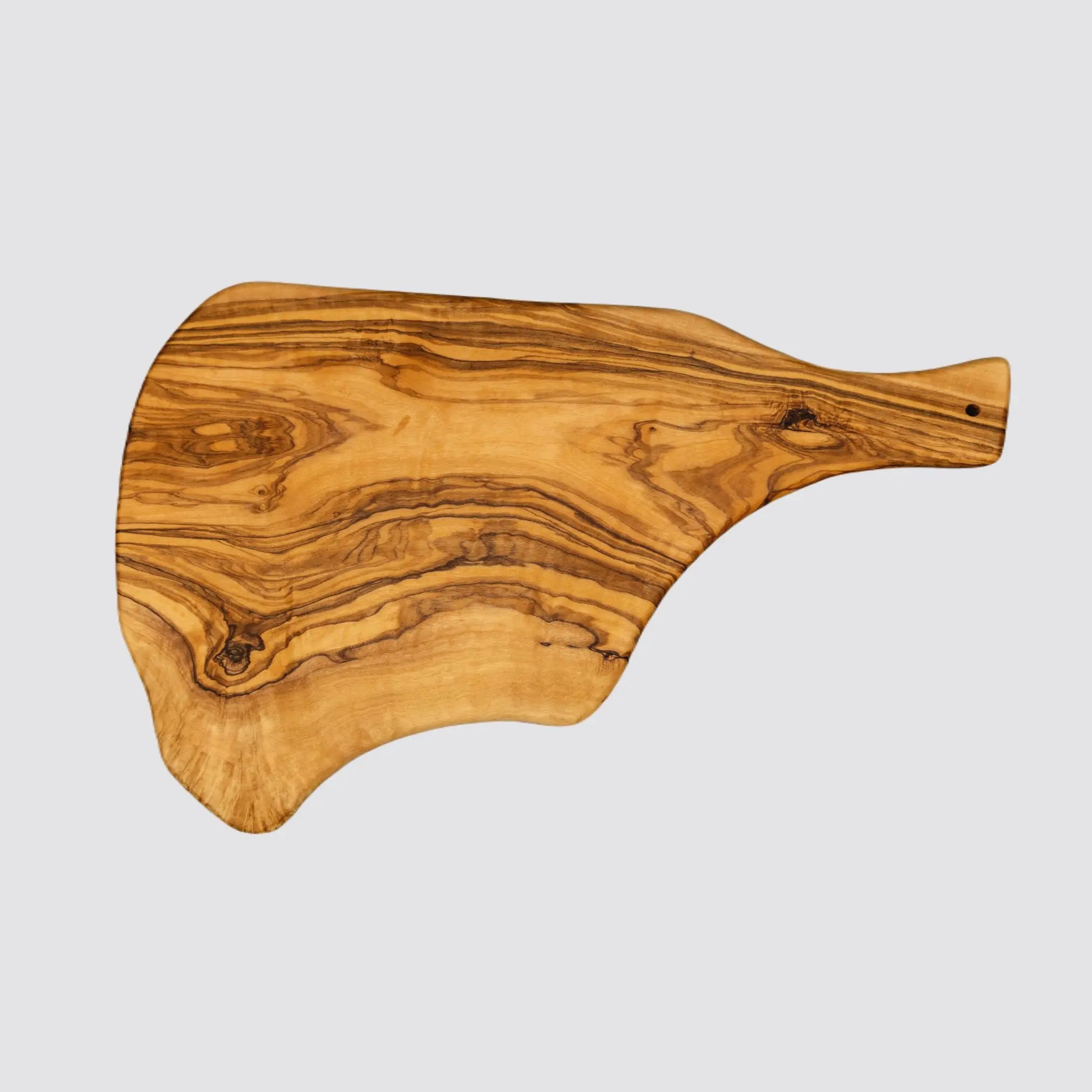Back view of a rustic olive wood charcuterie board with handle showcasing the natural grain on the reverse side on a plain white background.