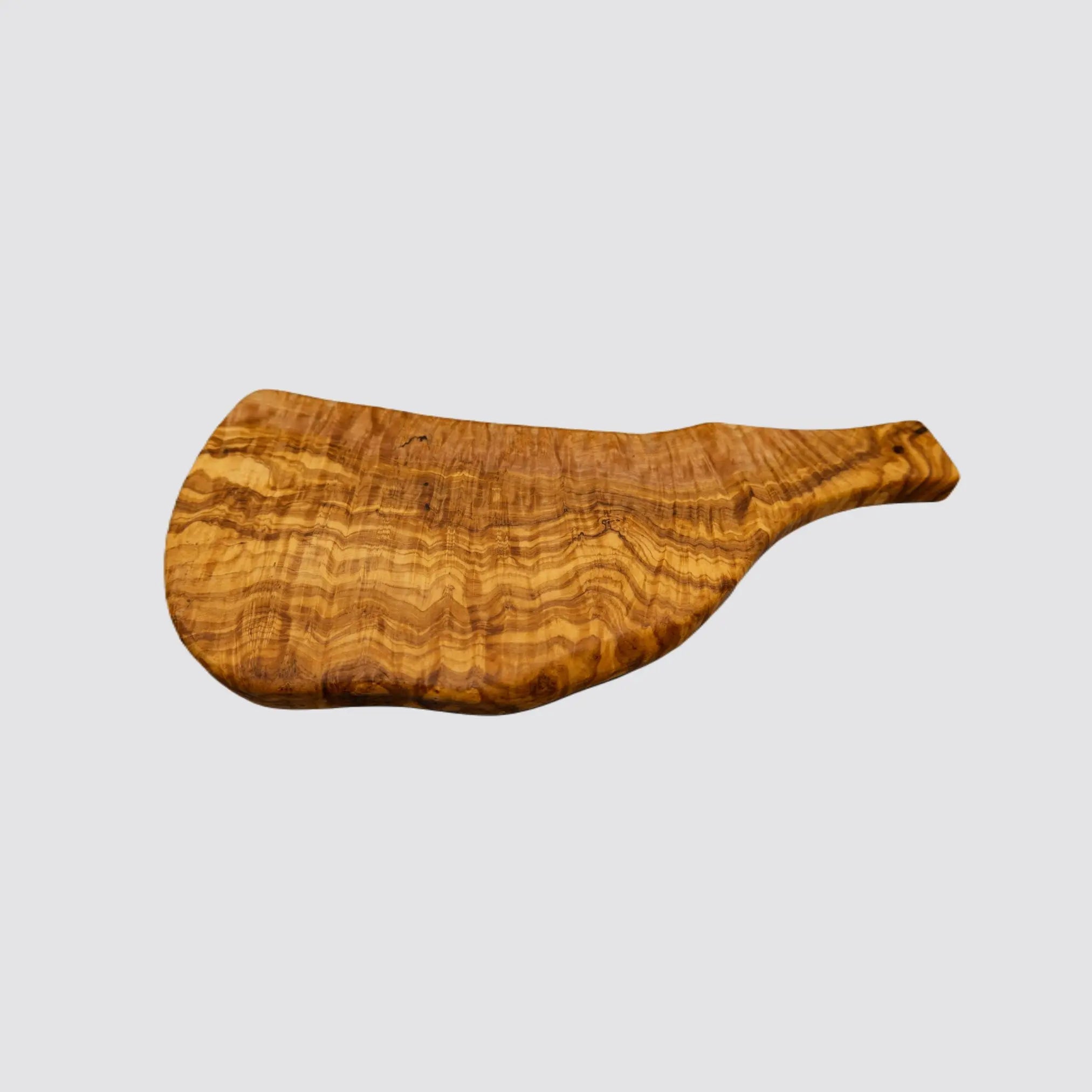 Angled view of a handcrafted olive wood serving board, emphasizing its rustic edges and natural texture on a plain white background.