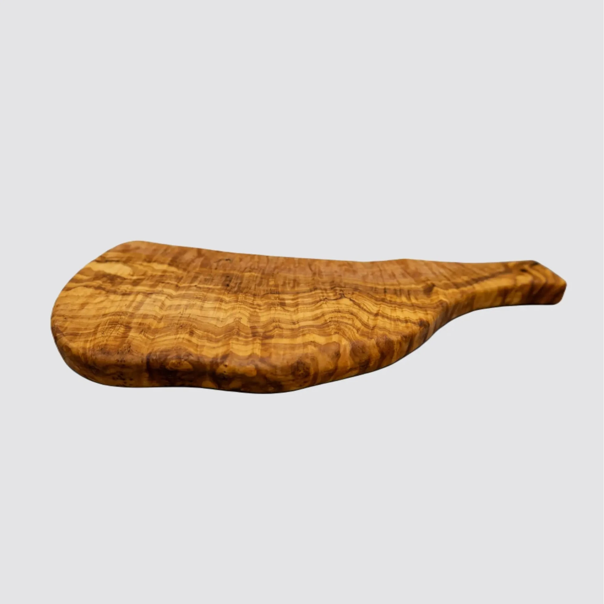 Side view of a handcrafted olive wood serving board, highlighting its natural thickness and organic edges on a plain white background.