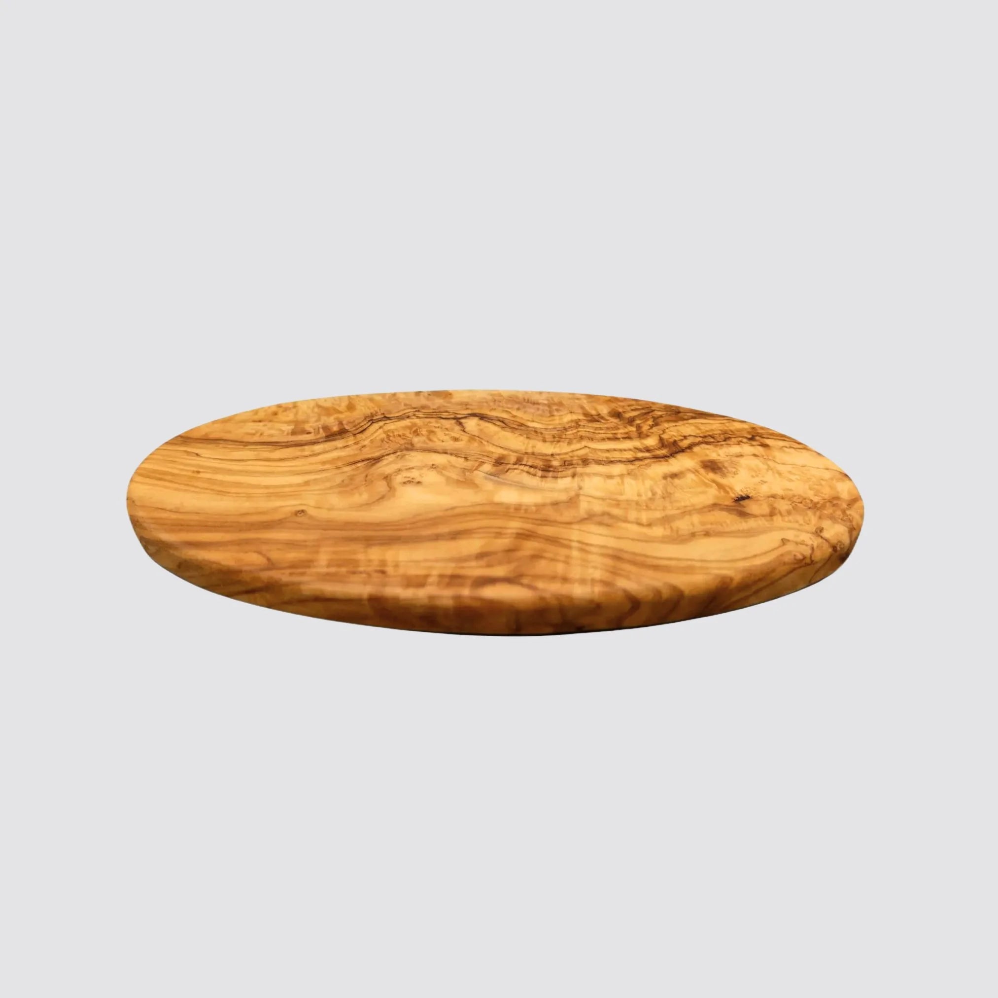 Front view of a handcrafted oval olive wood serving board showcasing its smooth finish and unique grain patterns.