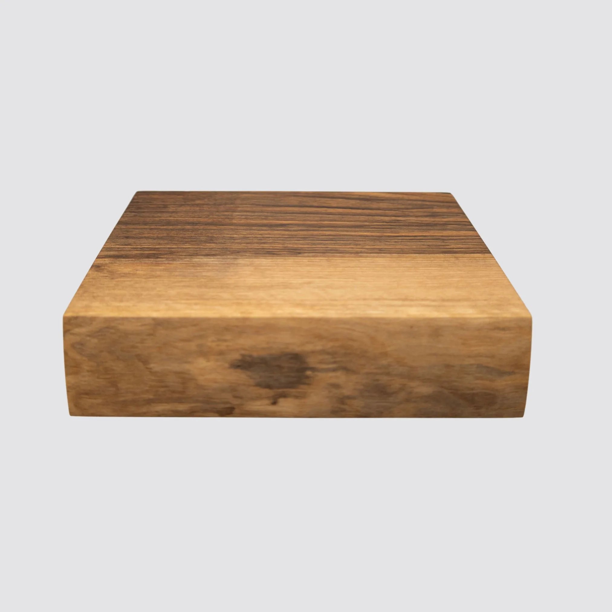Front view of a handcrafted walnut butcher block showcasing its rich grain patterns.