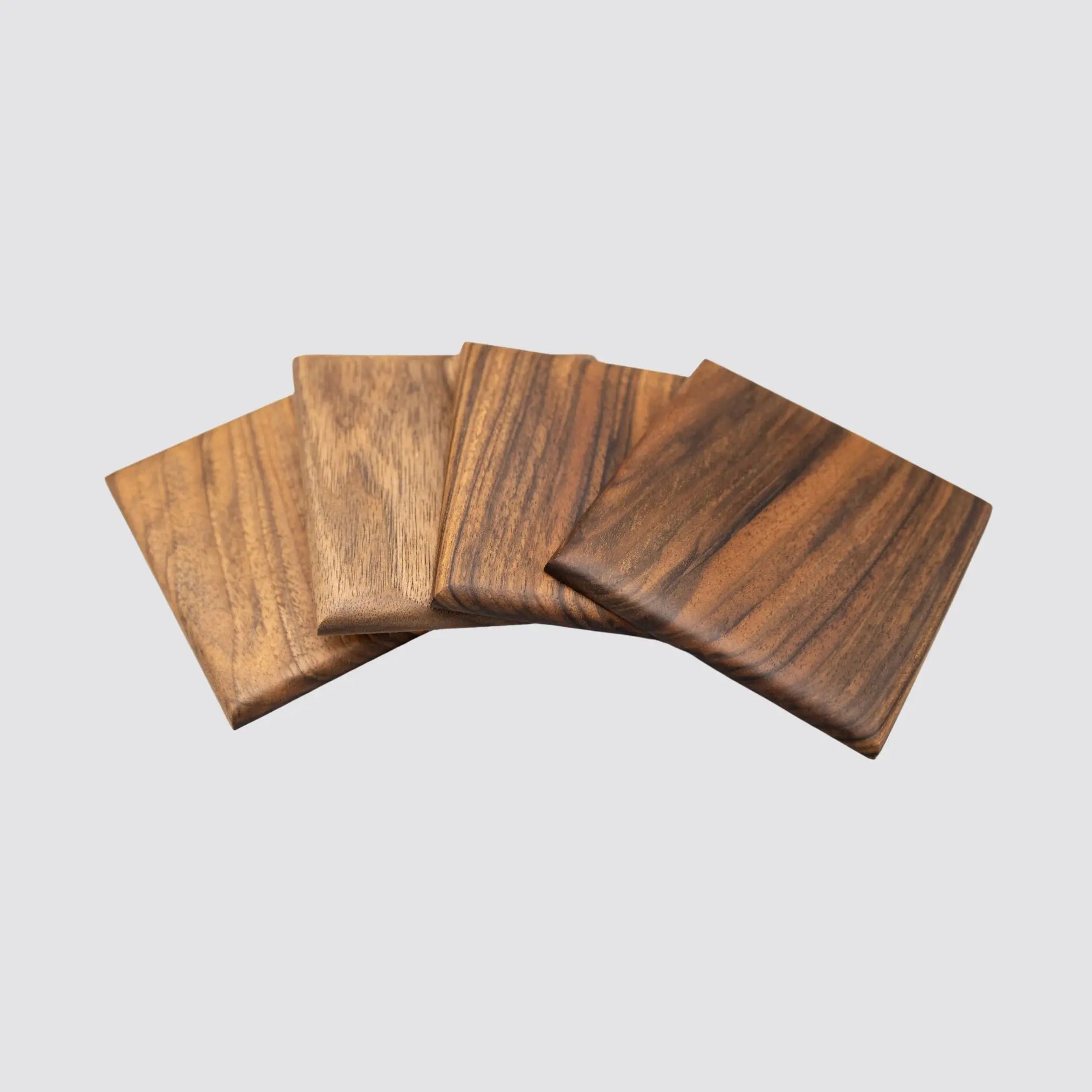 Handcrafted walnut coasters arranged on a flat surface, ready for gifting.
