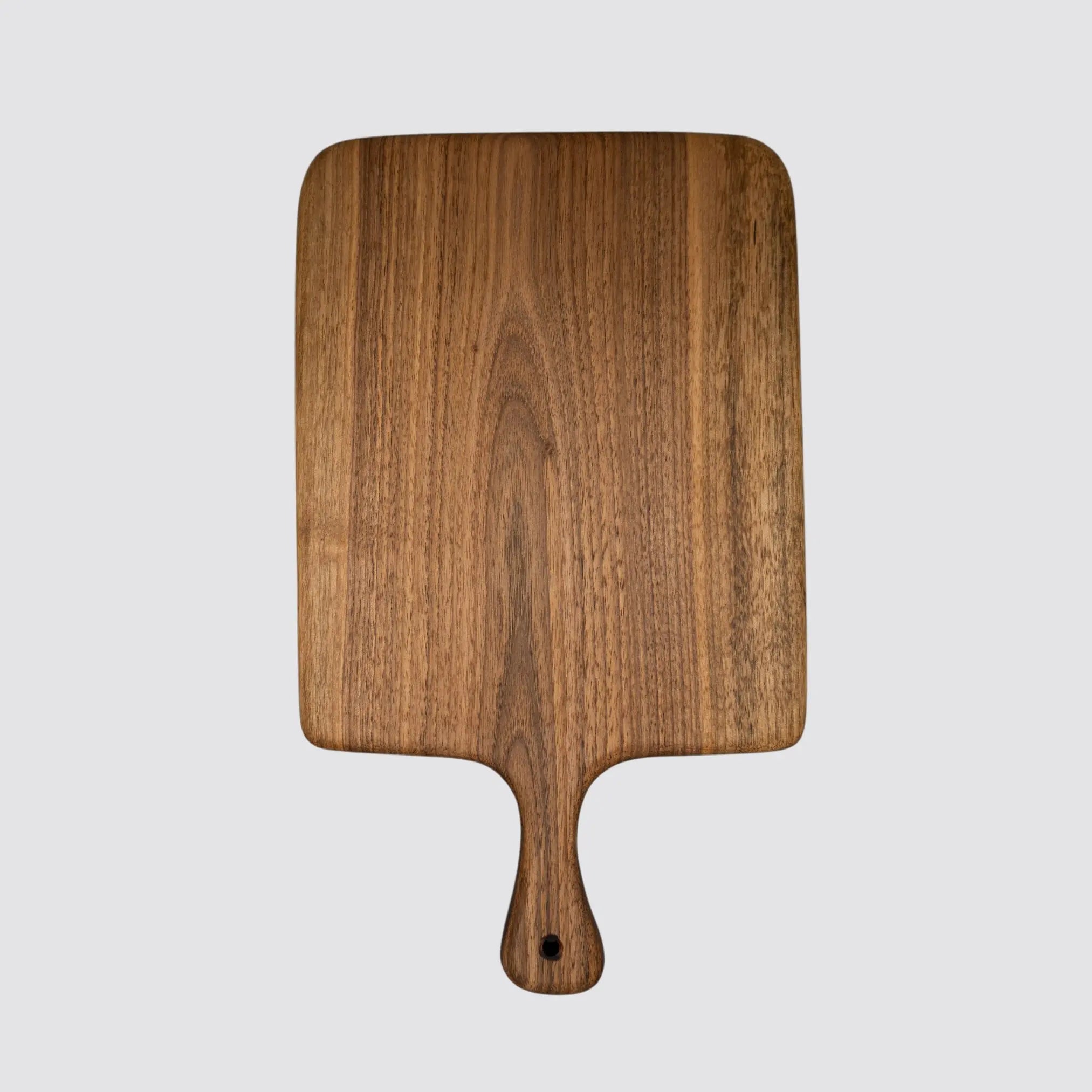 The walnut cutting board displaying its natural wood grain and premium style.