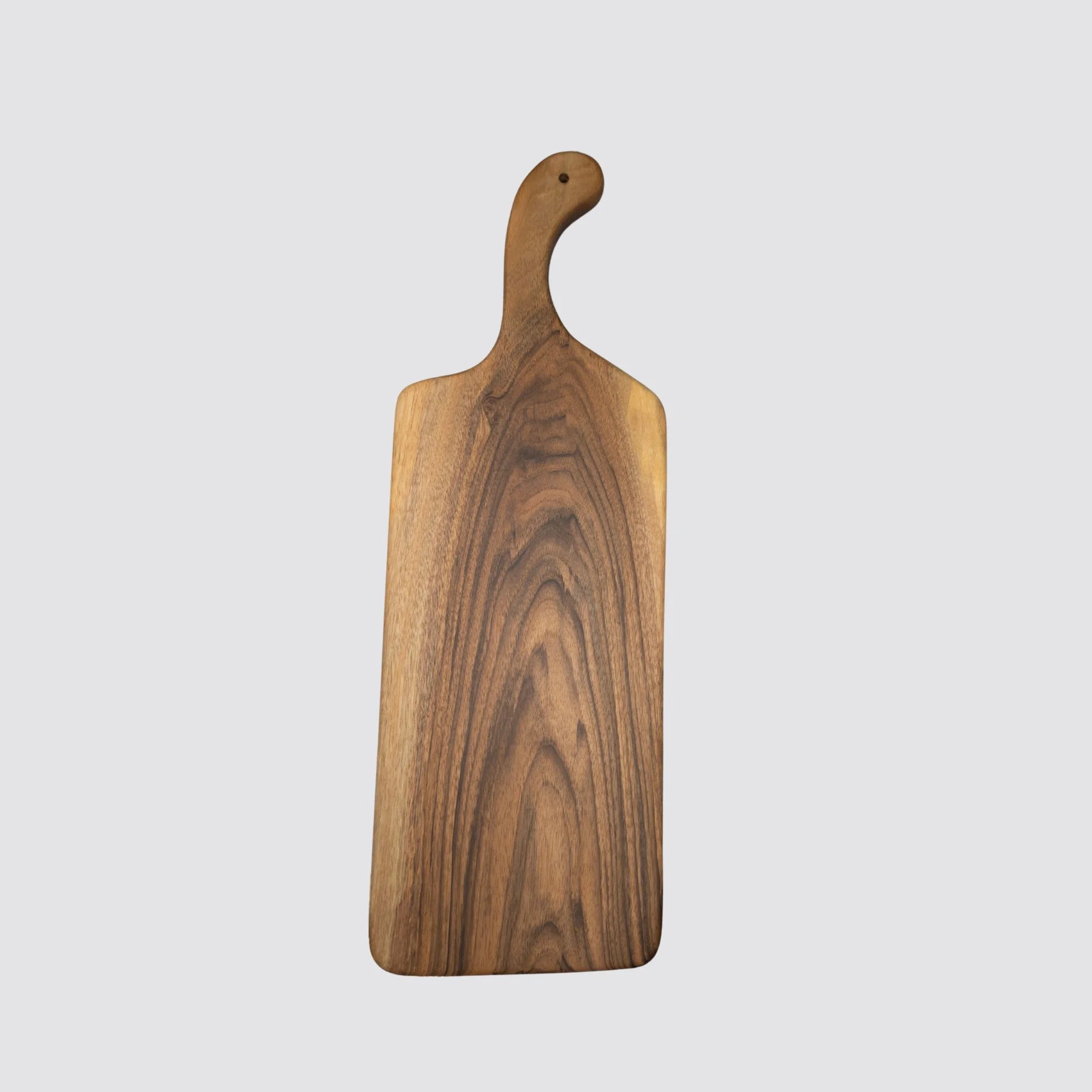 Long walnut cheese and charcuterie serving board or platter featuring a handle for easy serving.