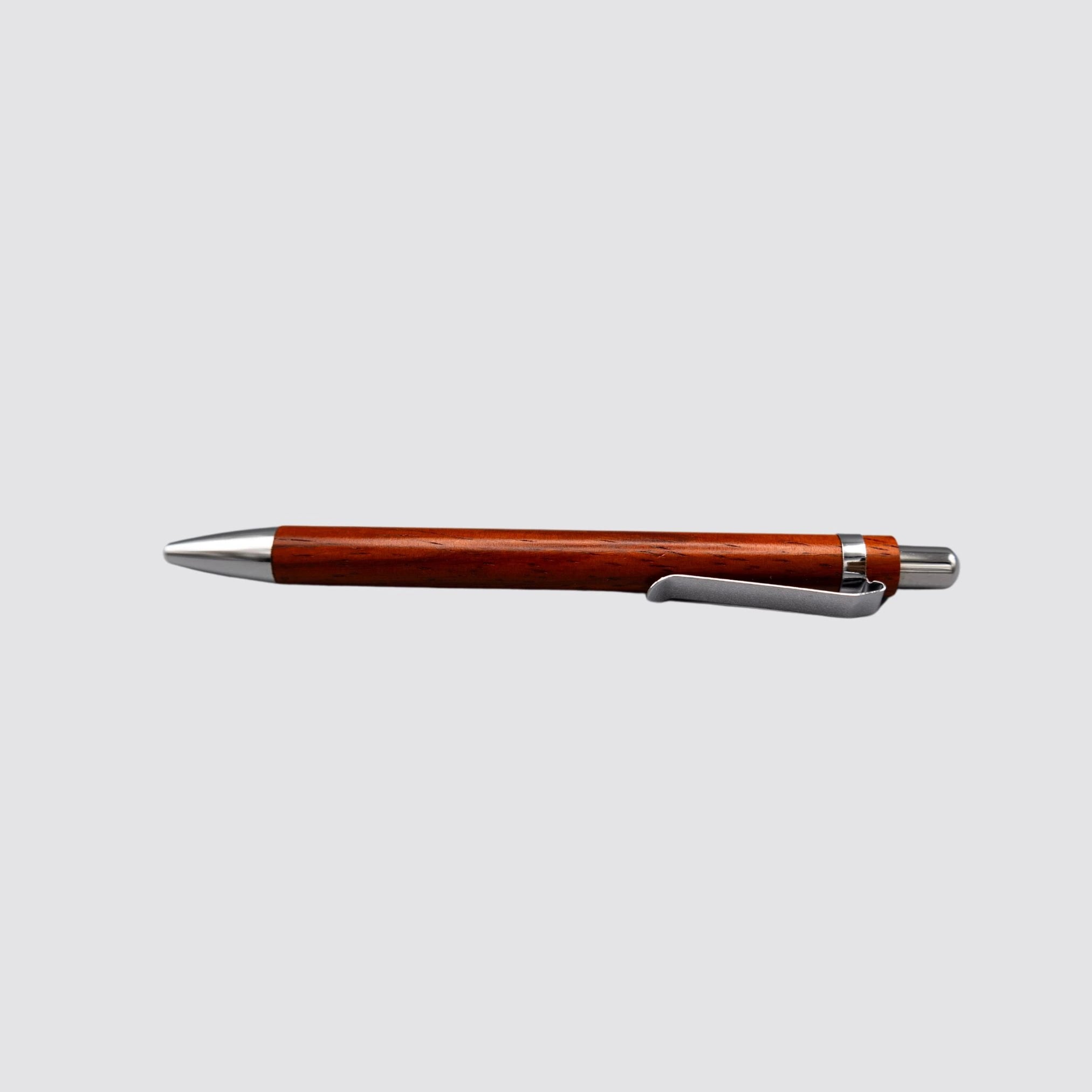 Side profile of a luxury rosewood ballpoint pen, highlighting its refined craftsmanship.