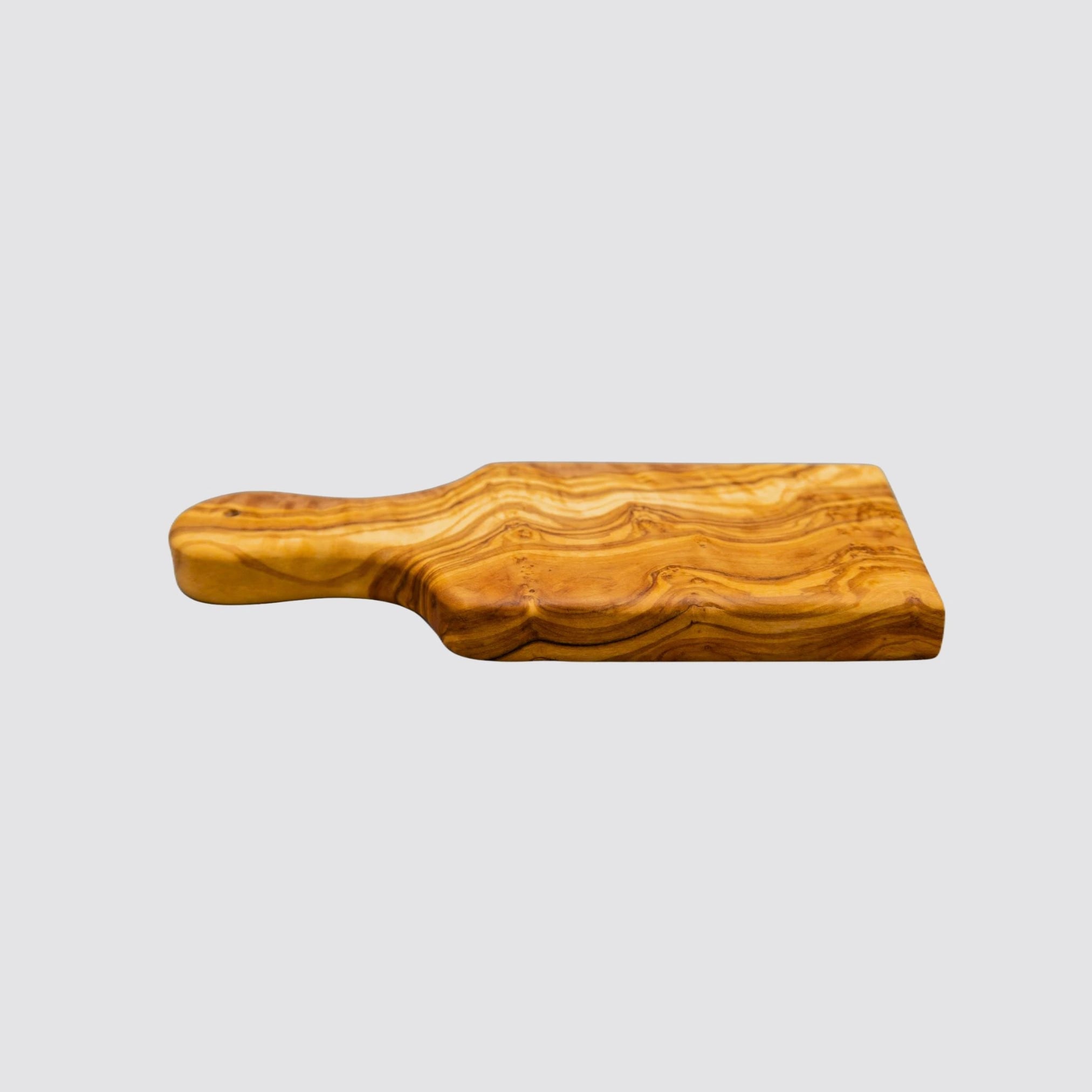 The luxury small serving board made of natural olive wood has a handle.