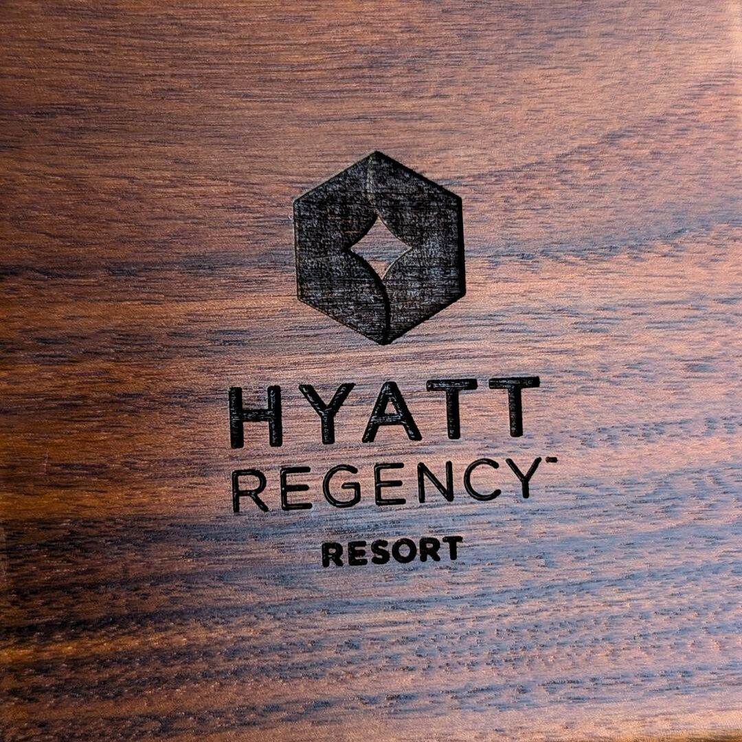 Hyatt Regency Resort logo on a wooden surface