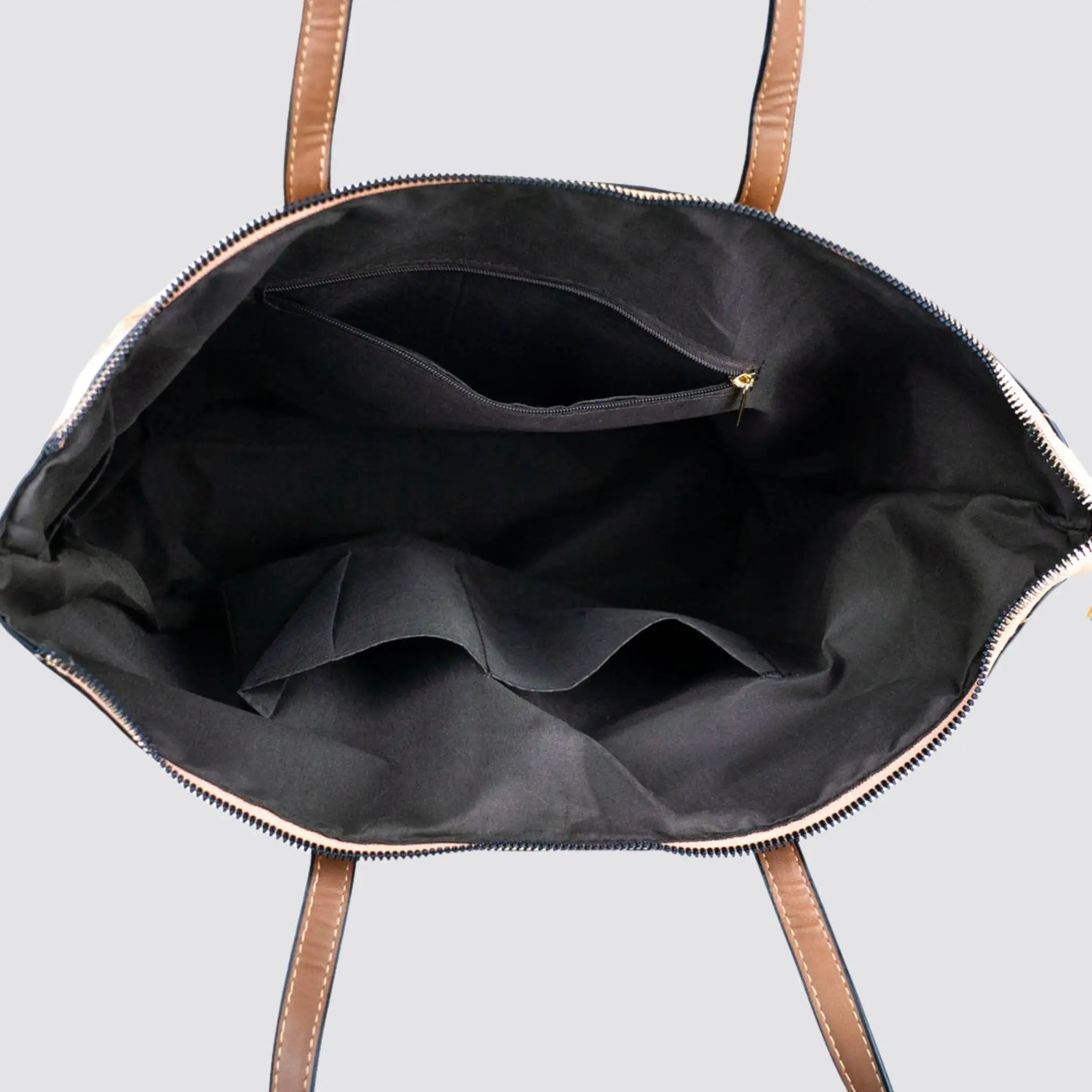Interior view of the Chic Natural and Printed Cork Tote Bag showing the black compartments for organization.