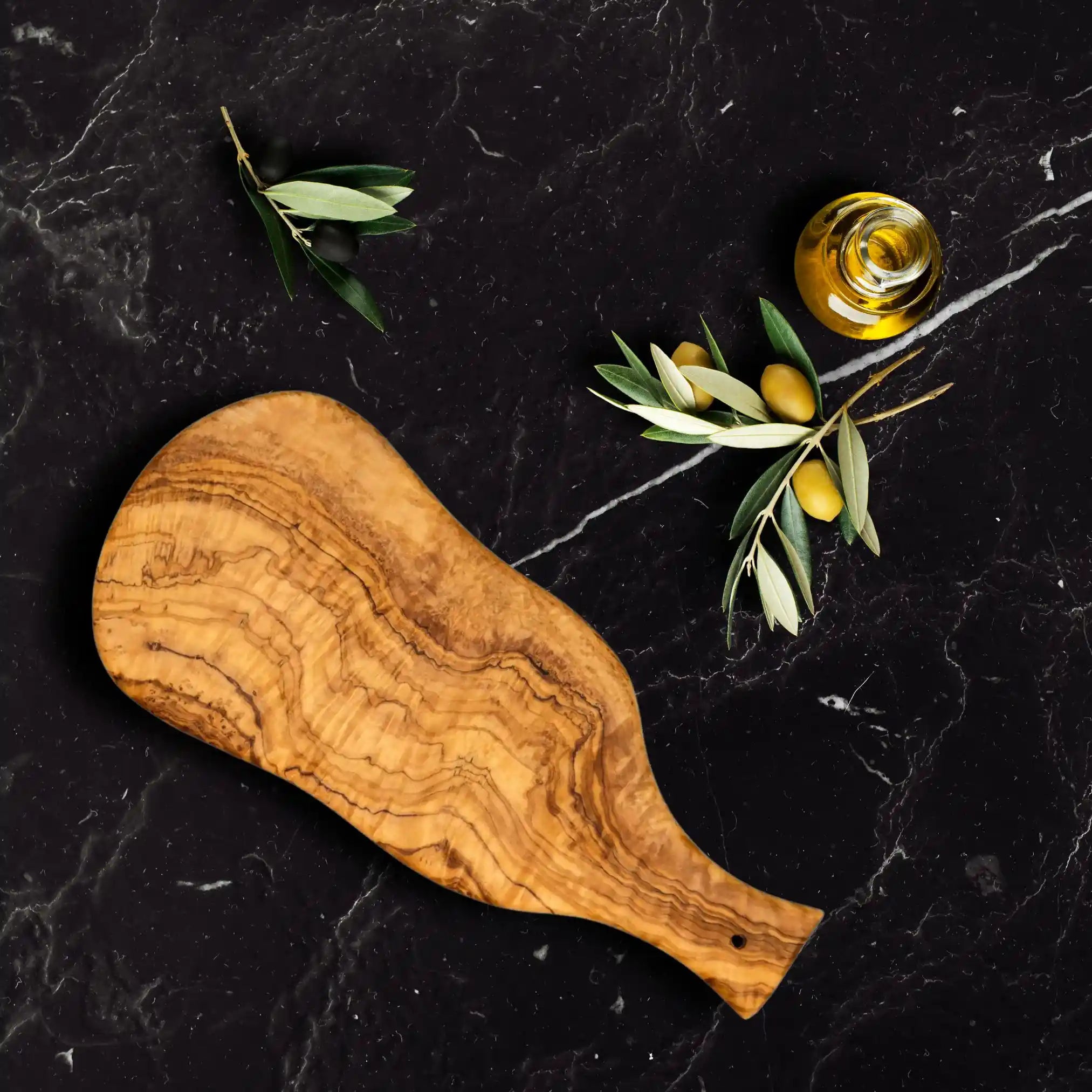 An olive breakfast board displayed elegantly on a luxurious marble table.