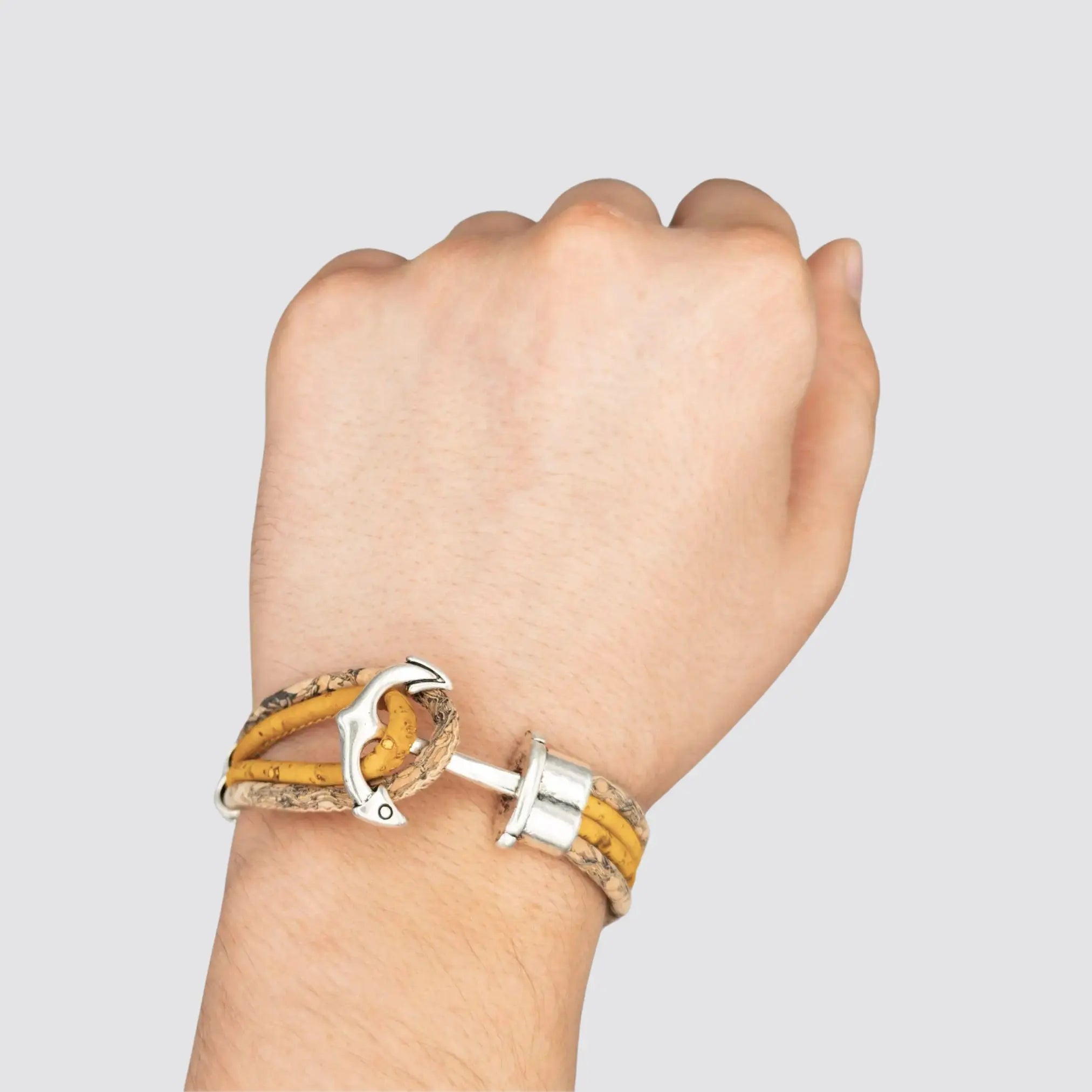 Orange cork bracelet worn on a wrist, illustrating its unisex appeal.