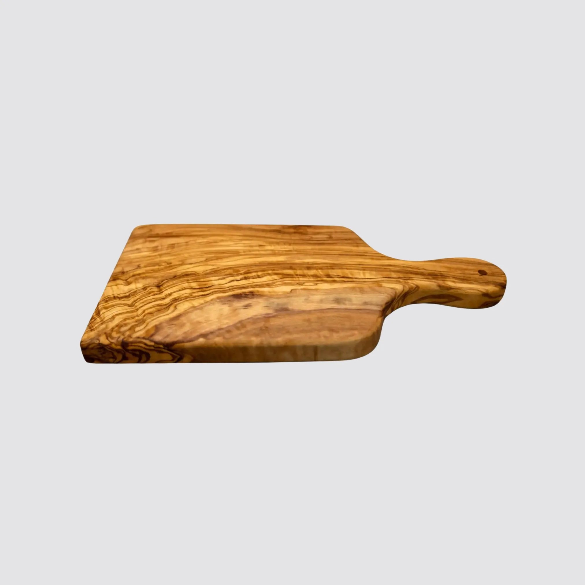 Side view of a premium olive wood cutting and serving board displaying its natural grain.