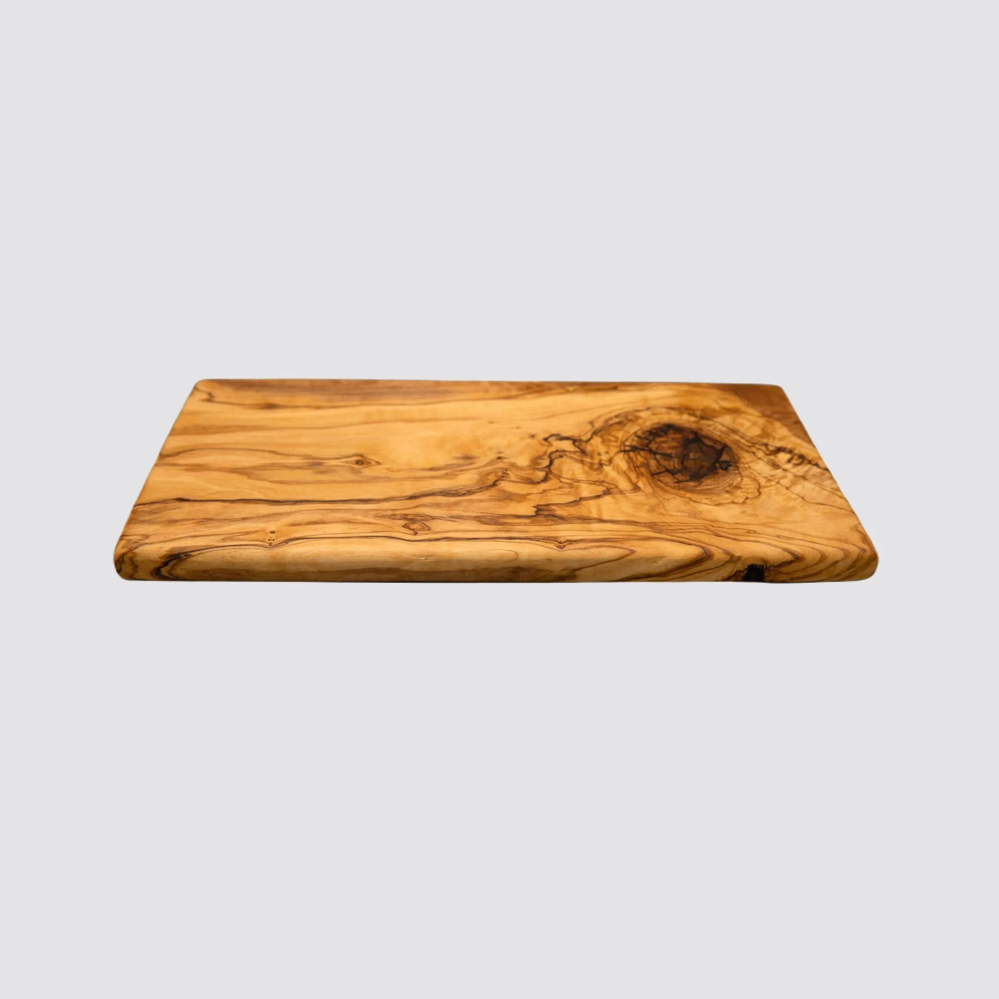 Rectangle olive wood serving board featuring a smooth finish and unique grain patterns.