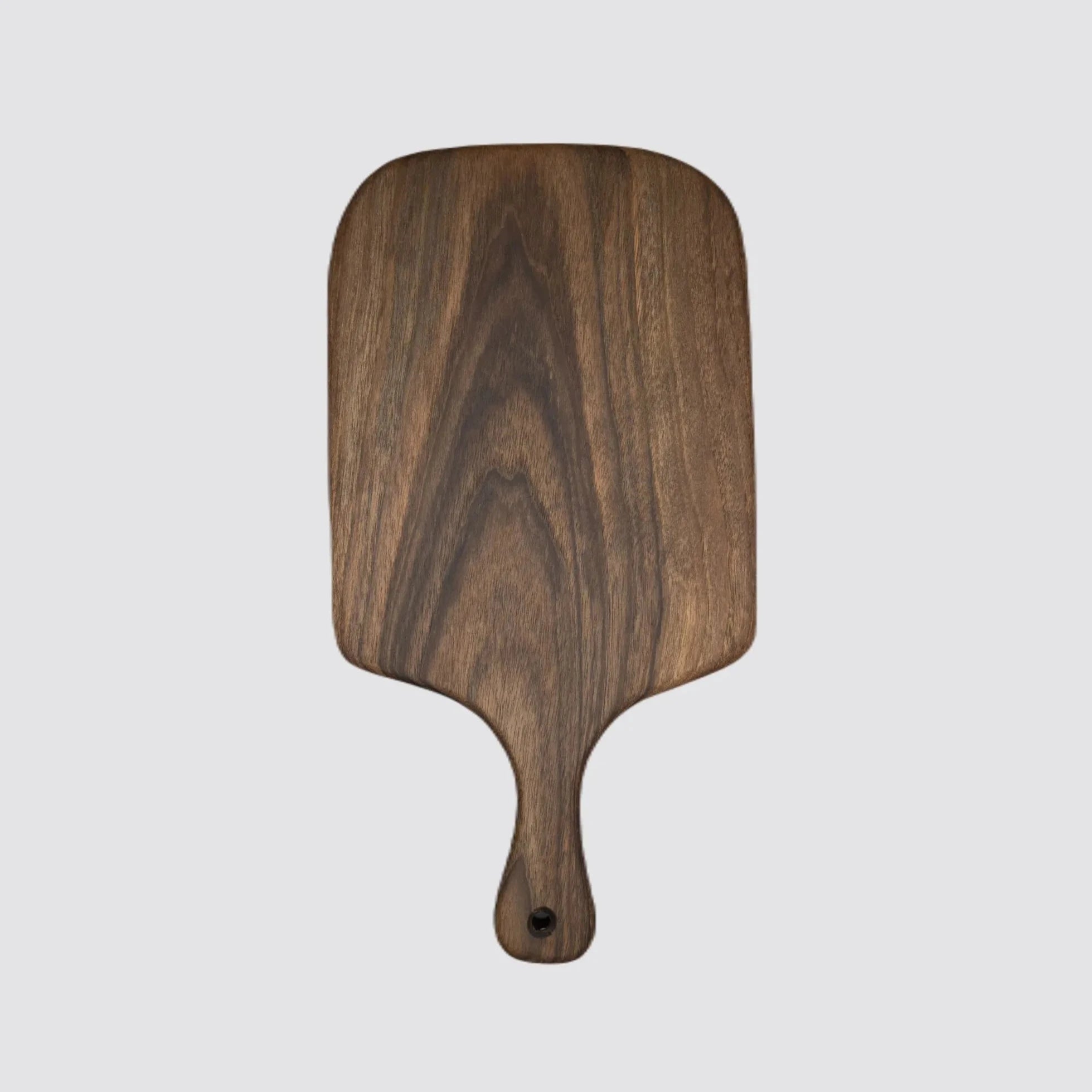Front view of a reversible walnut serving and cutting board, showcasing its polished finish.