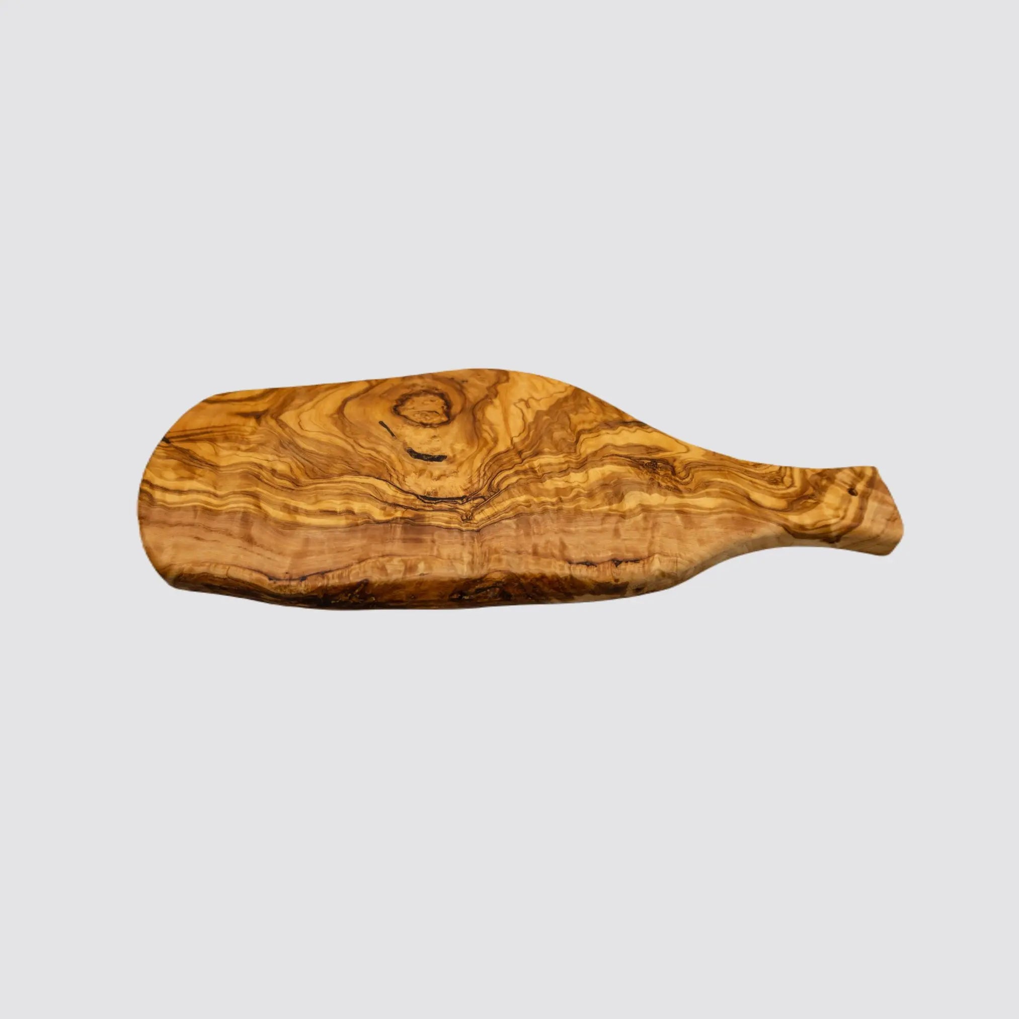Angled view of a rustic olive wood serving board, emphasizing its organic shape and warm wood tones on a plain white background.