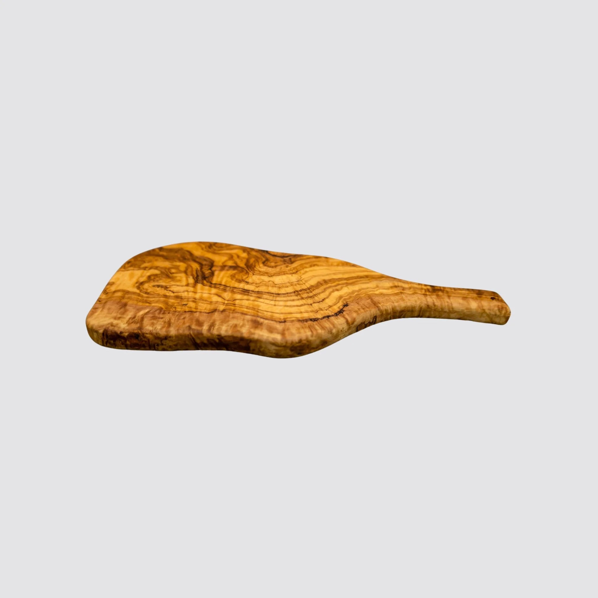 Side view of a rustic olive wood serving board showing the natural edges and thickness on a plain white background.