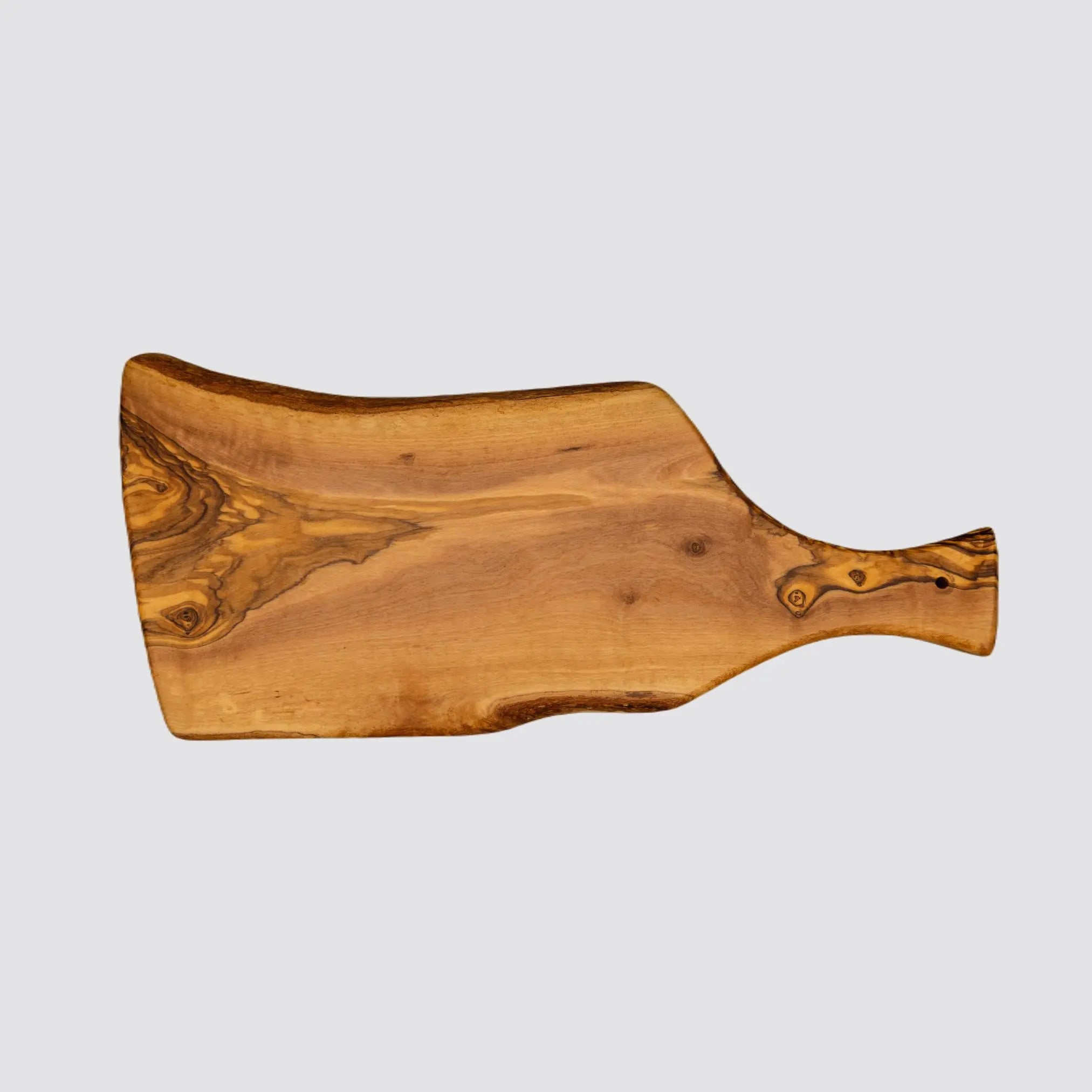 Back view of a rustic olive wood cheese board highlighting the grain patterns on the reverse side on a plain white background.