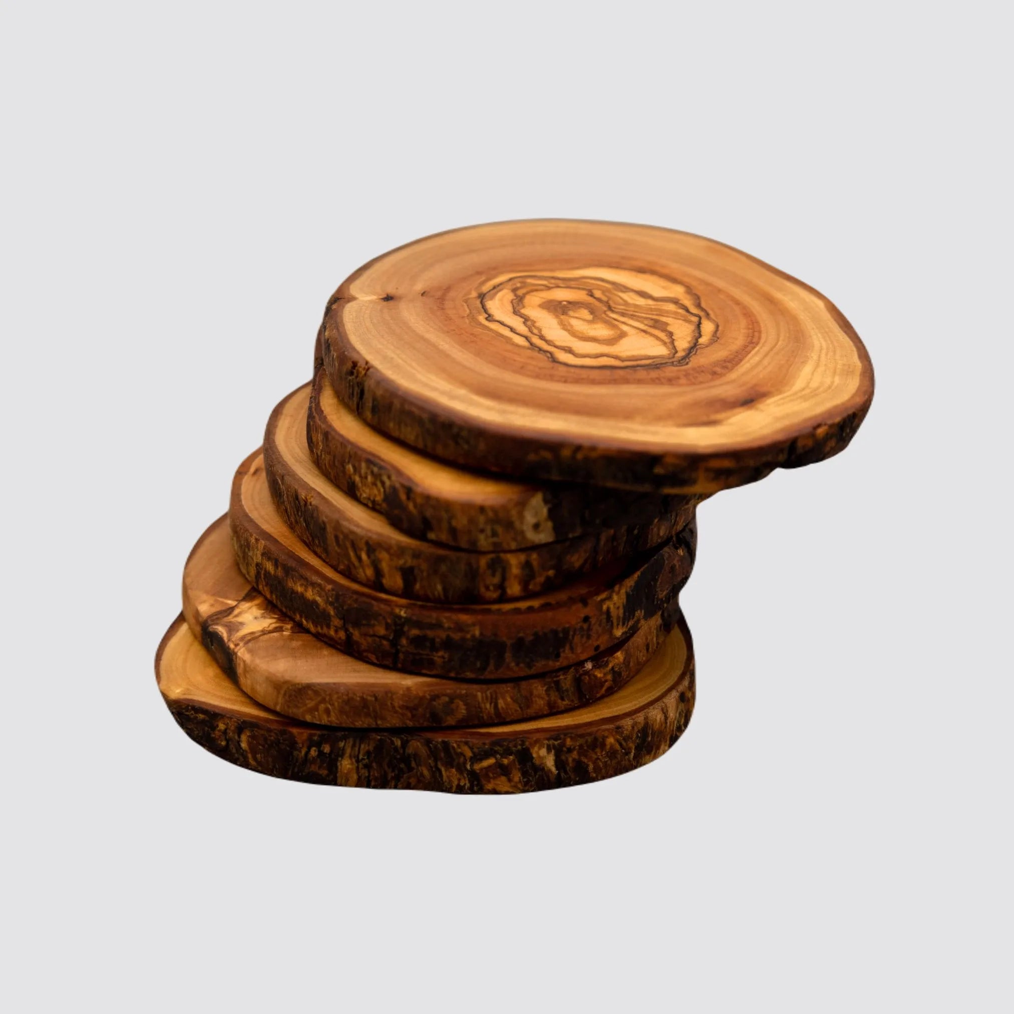 Rustic olive wood coaster set featuring unique natural grain patterns.