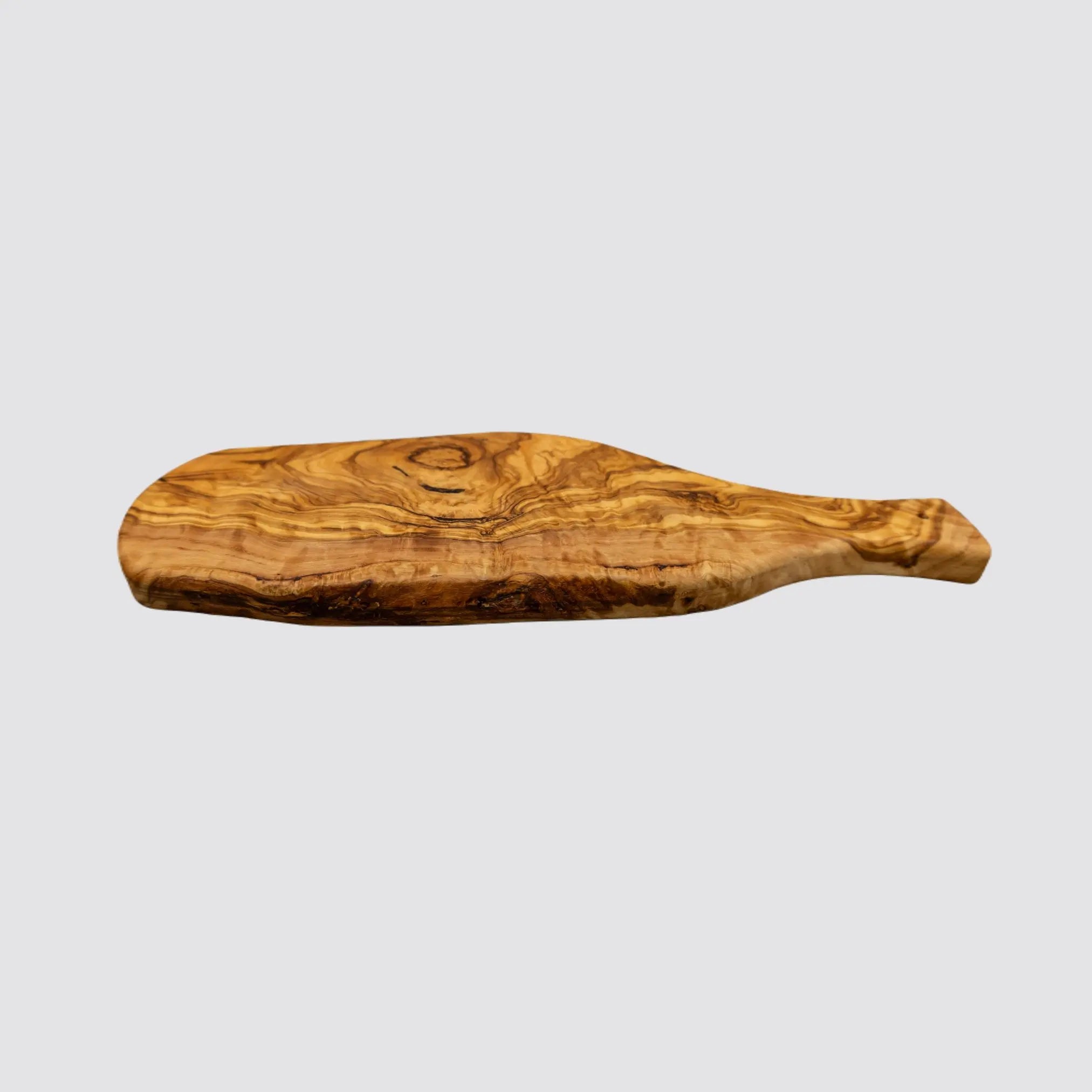 Close-up of the edge details of a rustic olive wood serving board, highlighting its thick, organic edges on a plain white background.