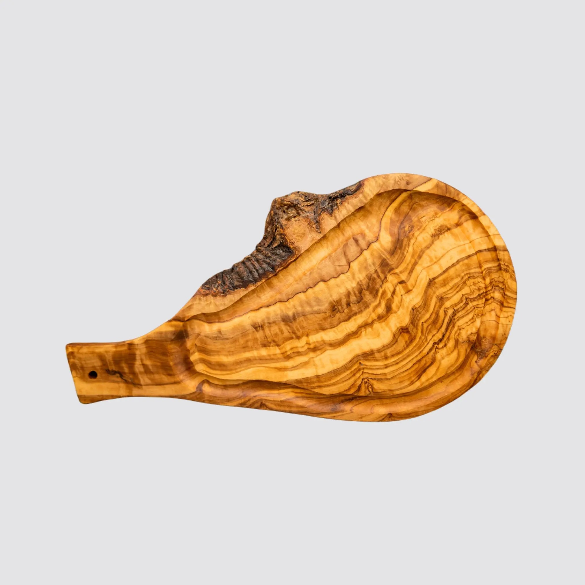 Rustic olive wood steak board with built-in juice groove for serving meats.