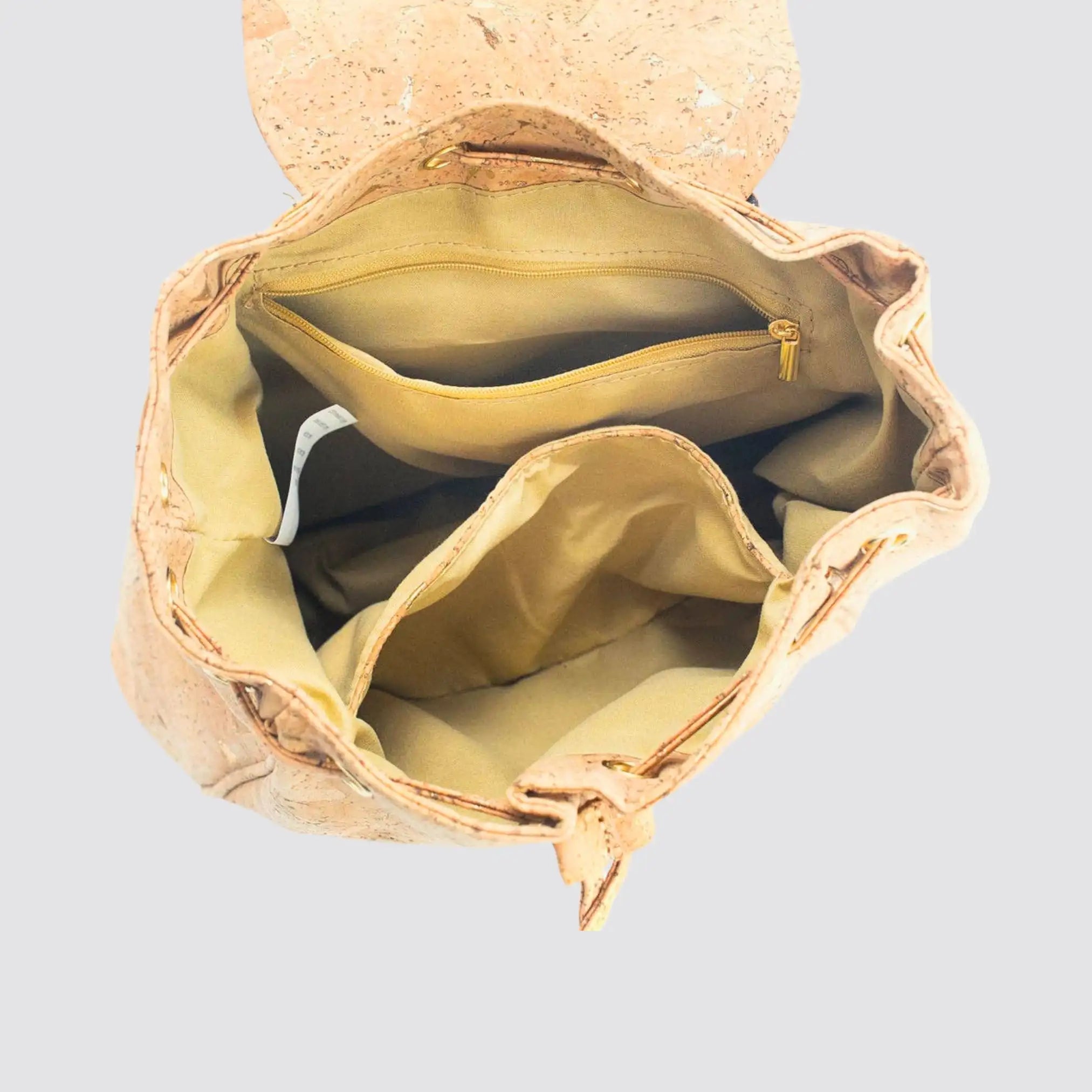 Spacious cork vegan leather backpack with interior divider for organization.