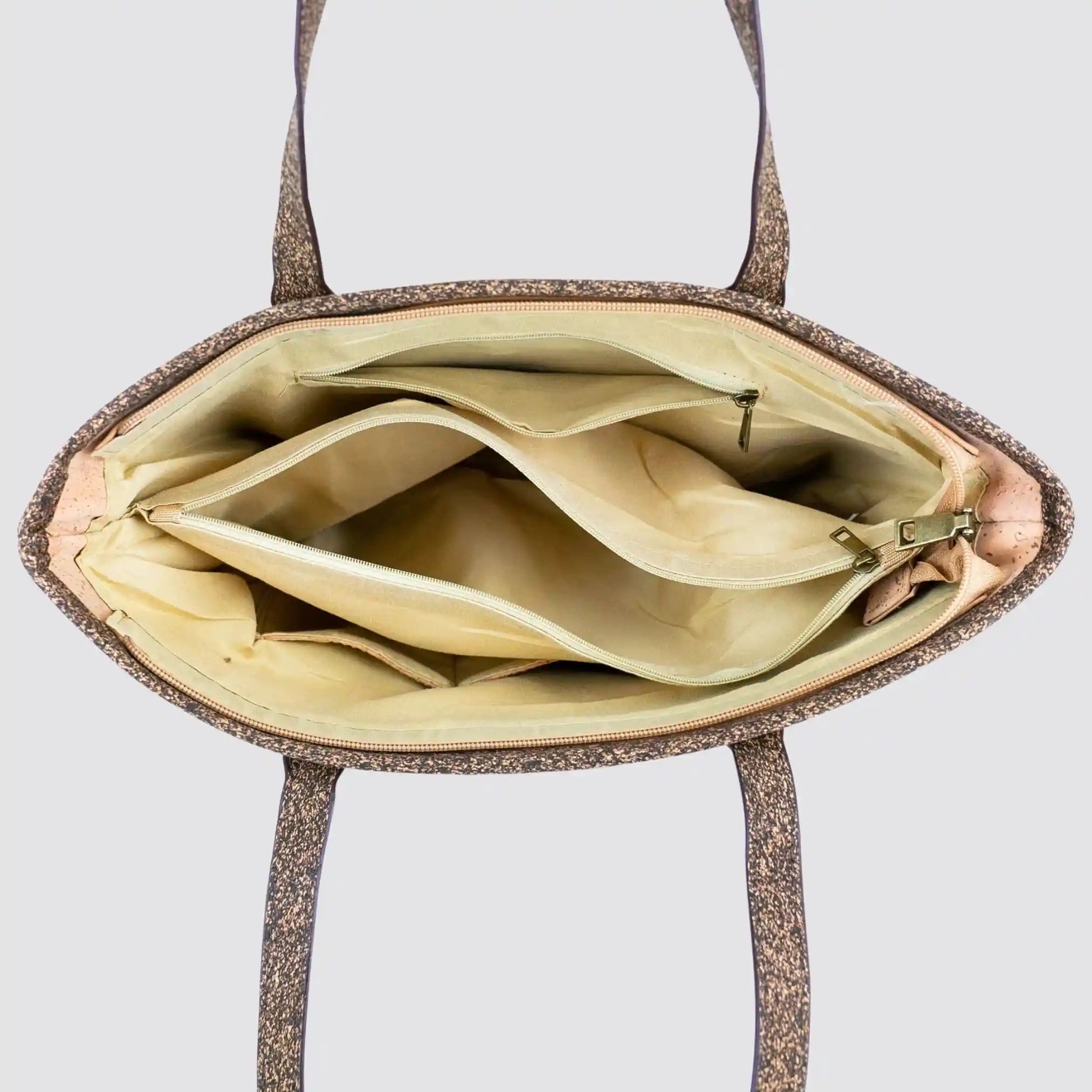 Stylish cork leather tote bag with multiple interior compartments.