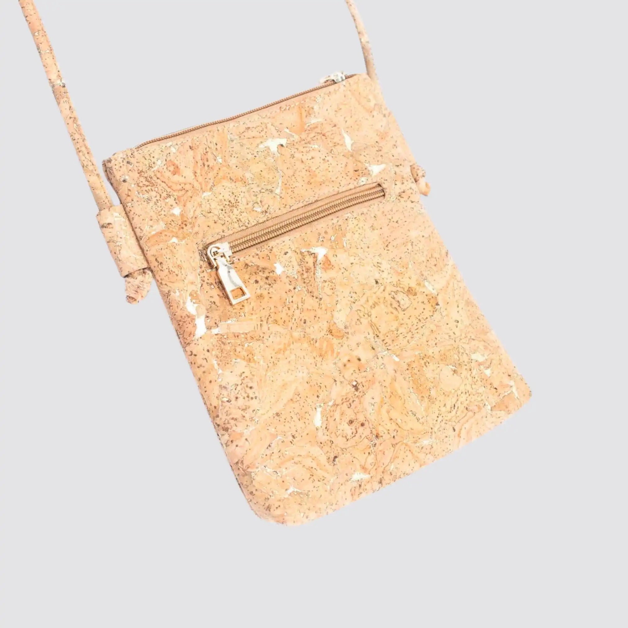 Stylish eco-friendly cork crossbody bag with multiple compartments.