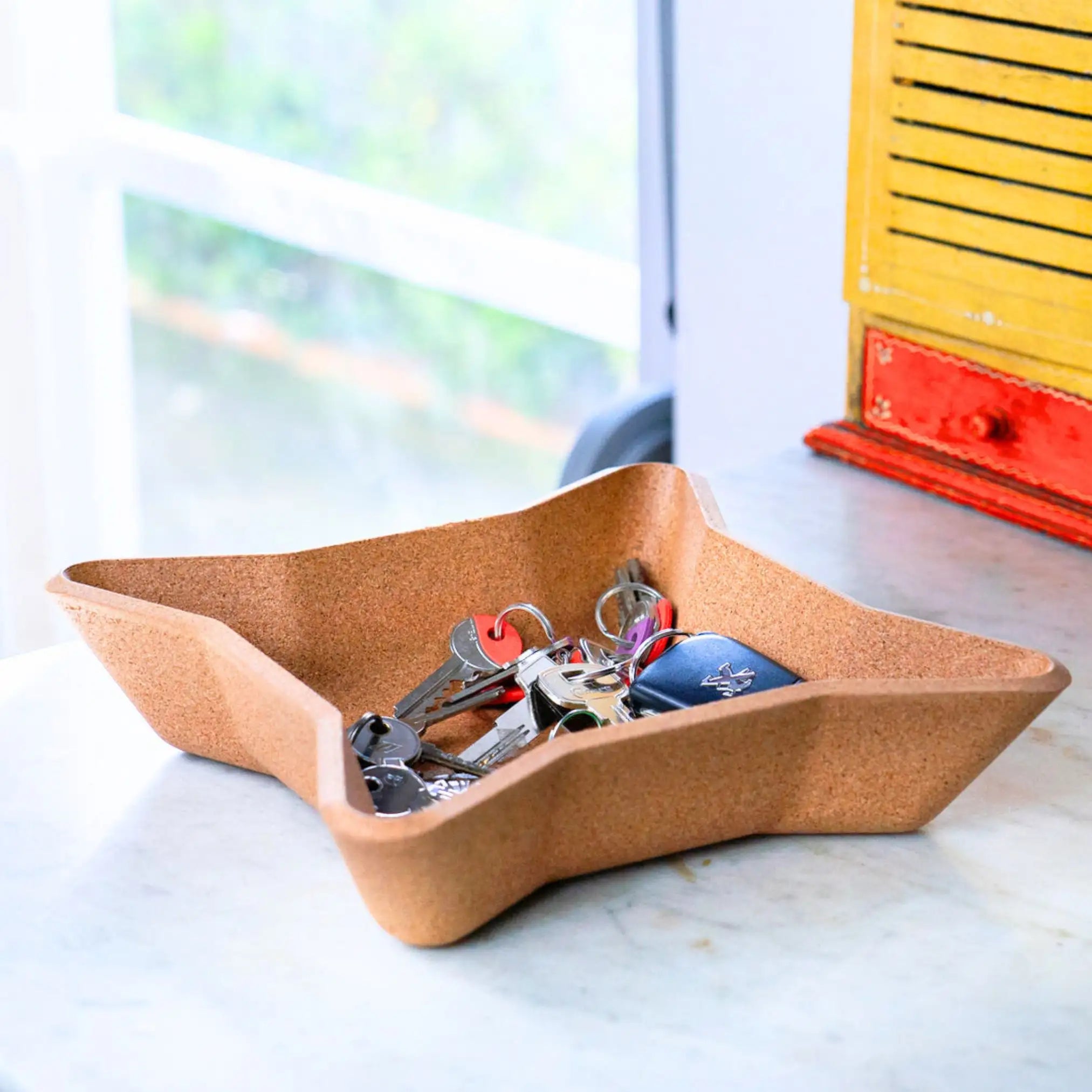 Stylish natural cork tray for organizing daily essentials.