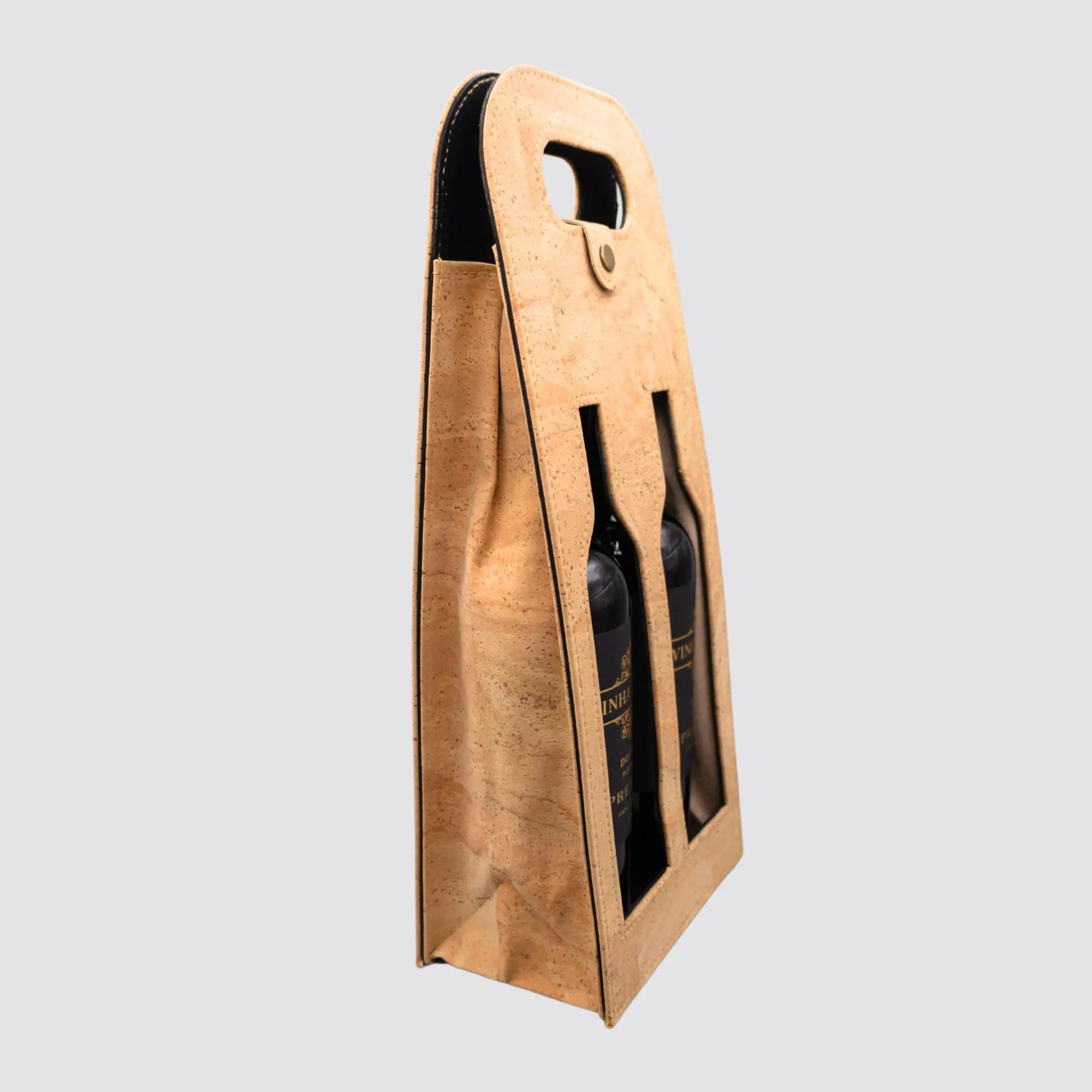 Sustainable dual-bottle cork wine carrier with a secure snap button closure.
