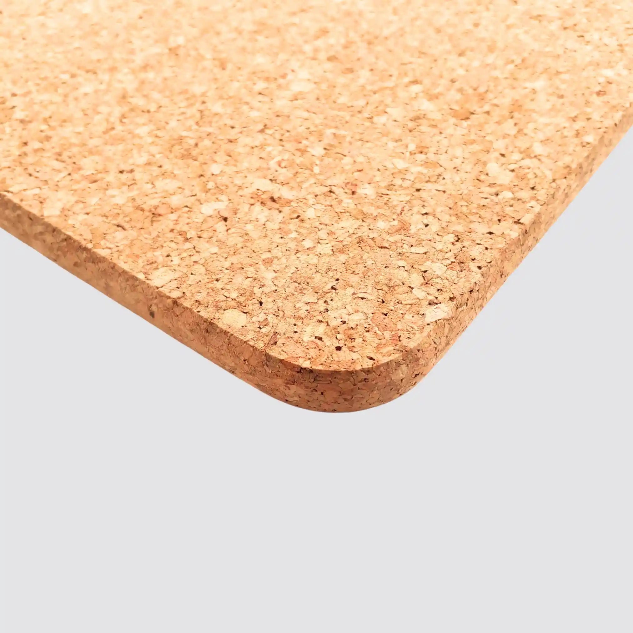 Durable cork placemat protecting surfaces from scratches and spills.
