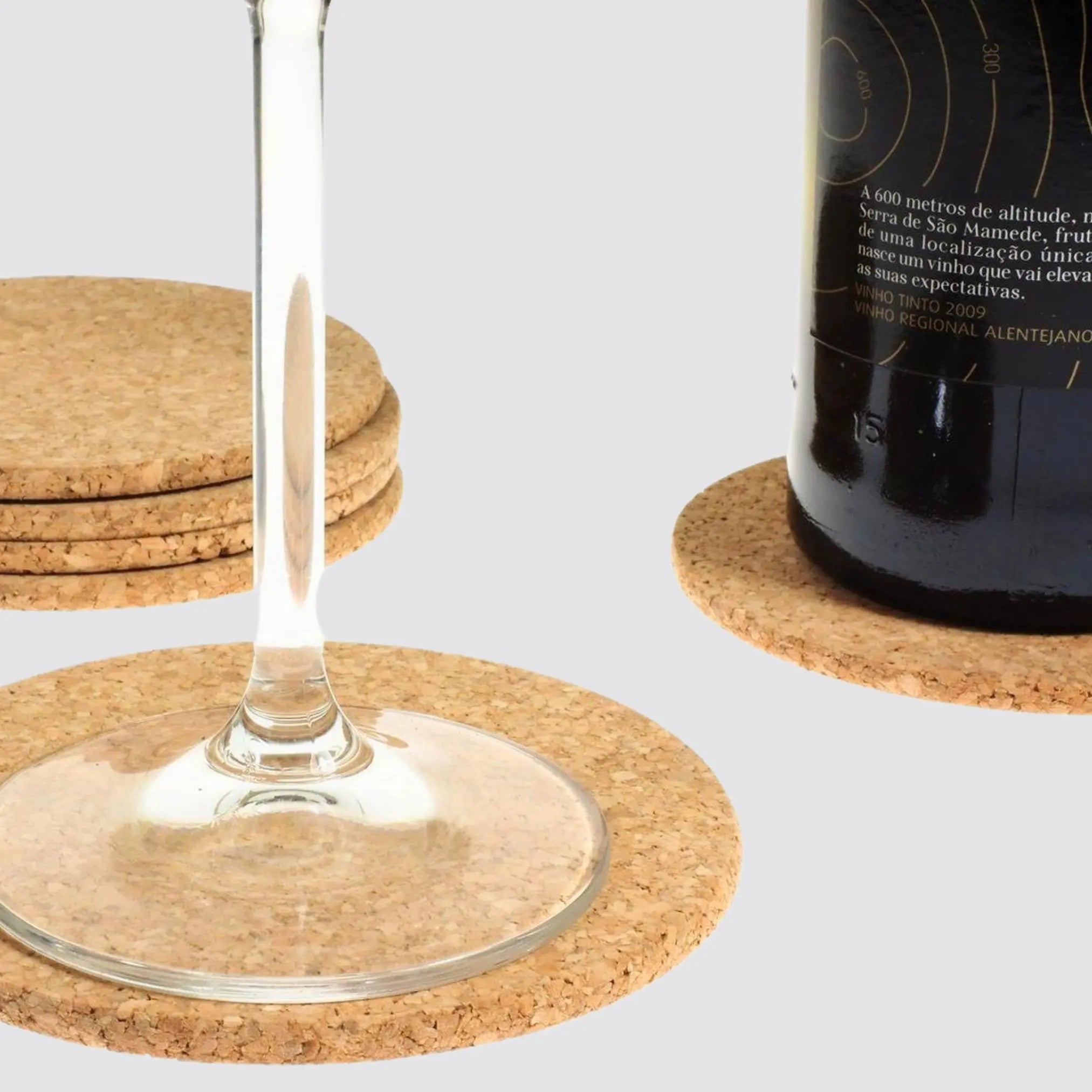 Sustainable round cork coaster holding a glass of wine.
