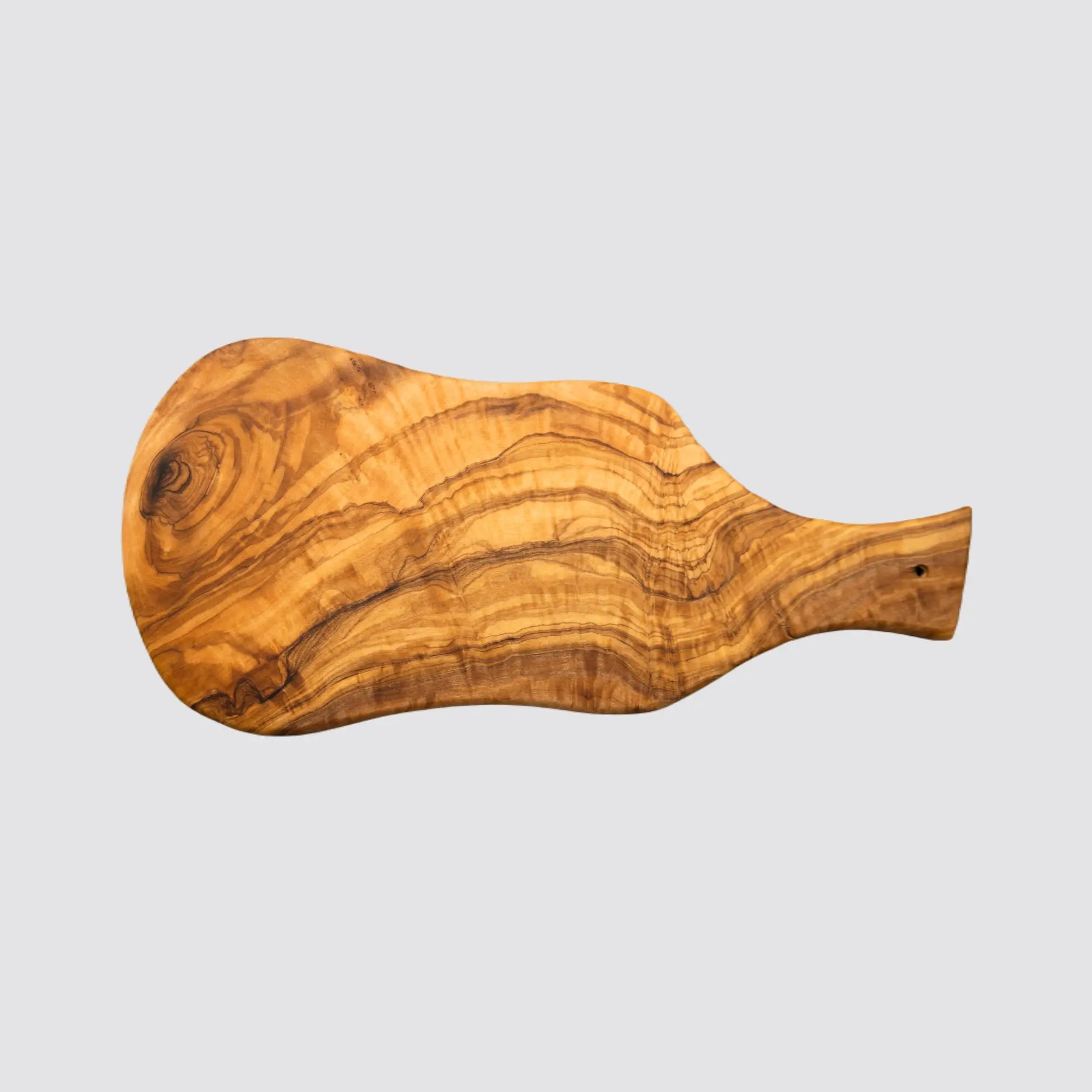 Versatile olive wood board for serving charcuterie and desserts.