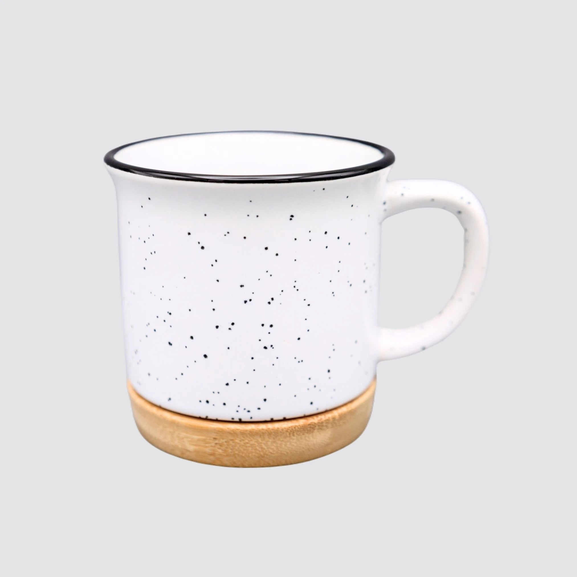 Vintage ceramic mug with a bamboo base and white speckled finish.