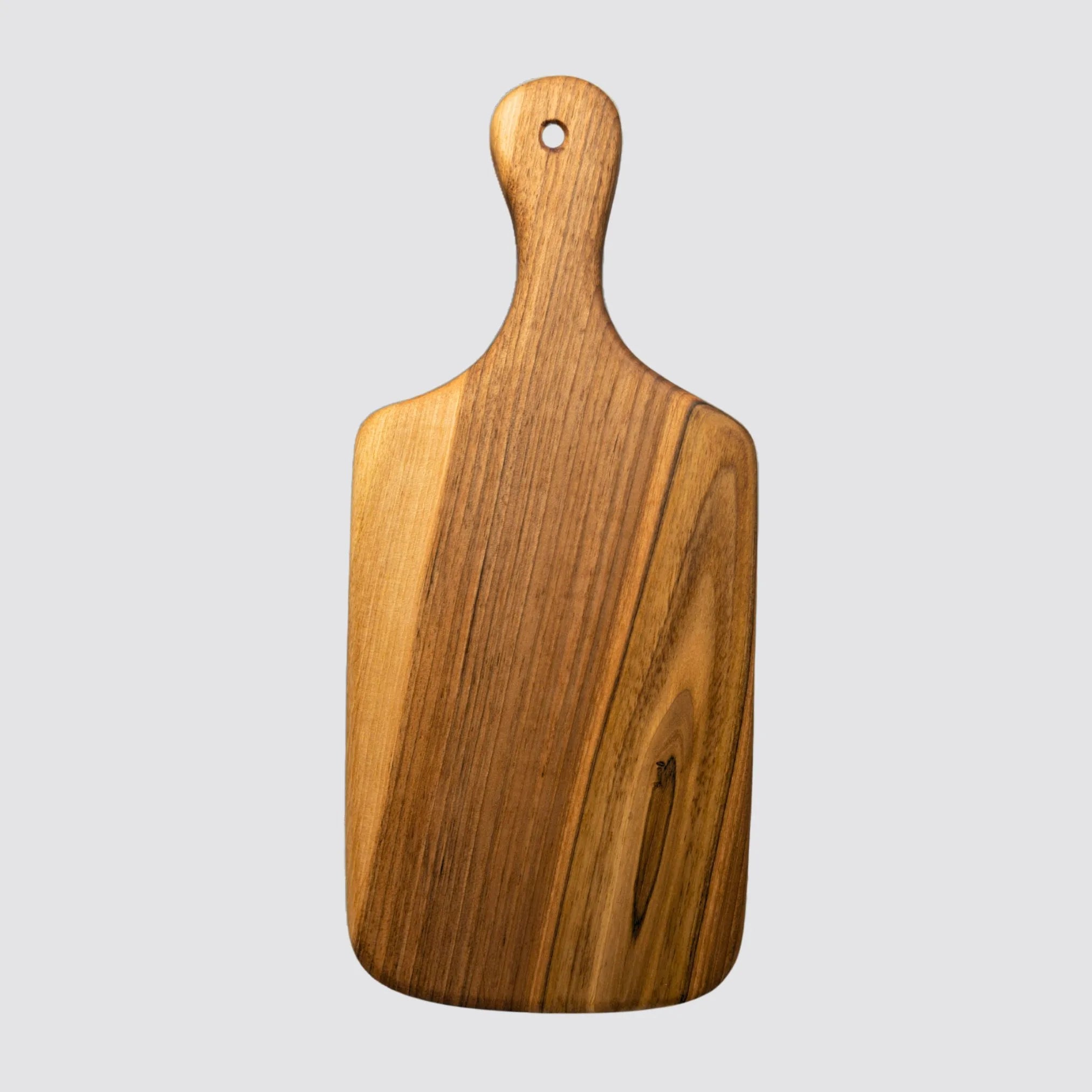The walnut cheese board with handle is displayed on a plain background highlighting its naturally elegant style.