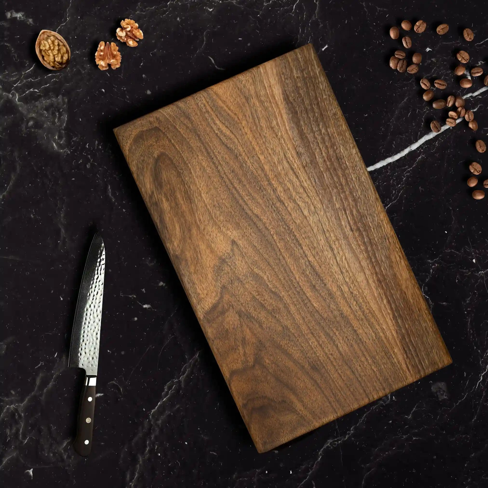 The walnut chopping board is displayed on a luxurious dining table.