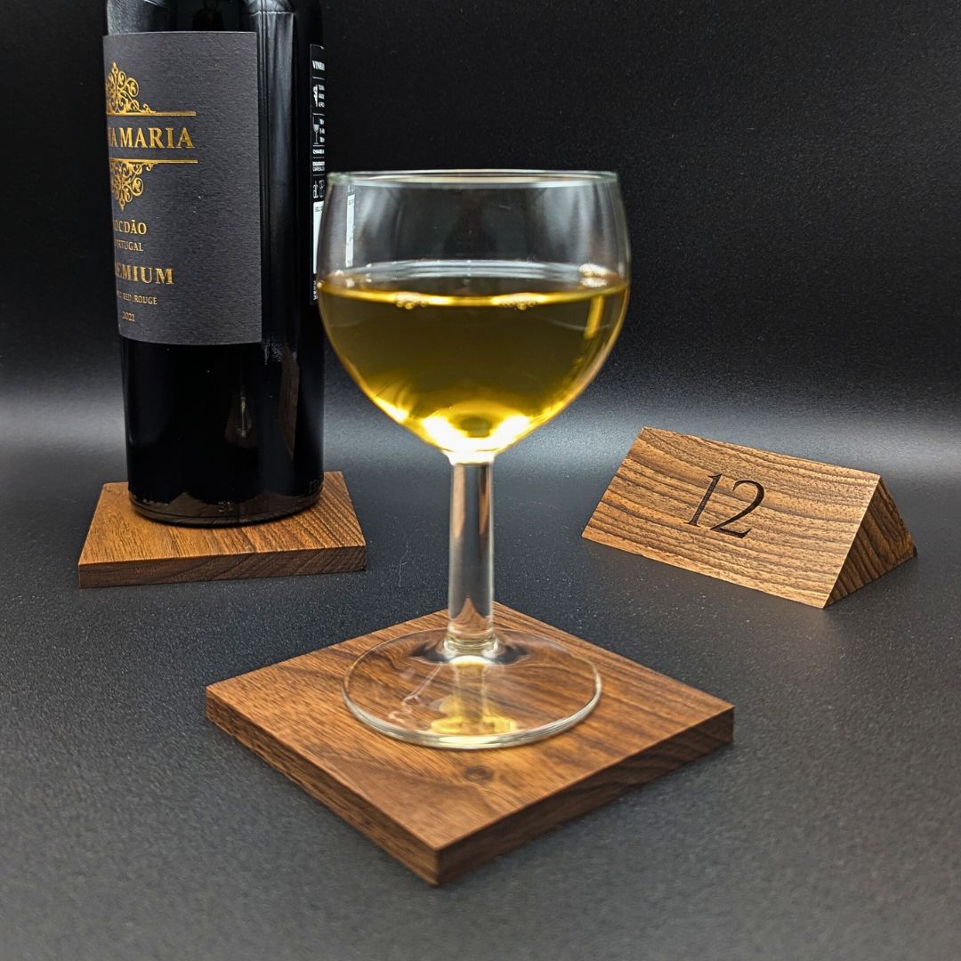 The walnut drink coasters are displayed on a luxury wooden table.