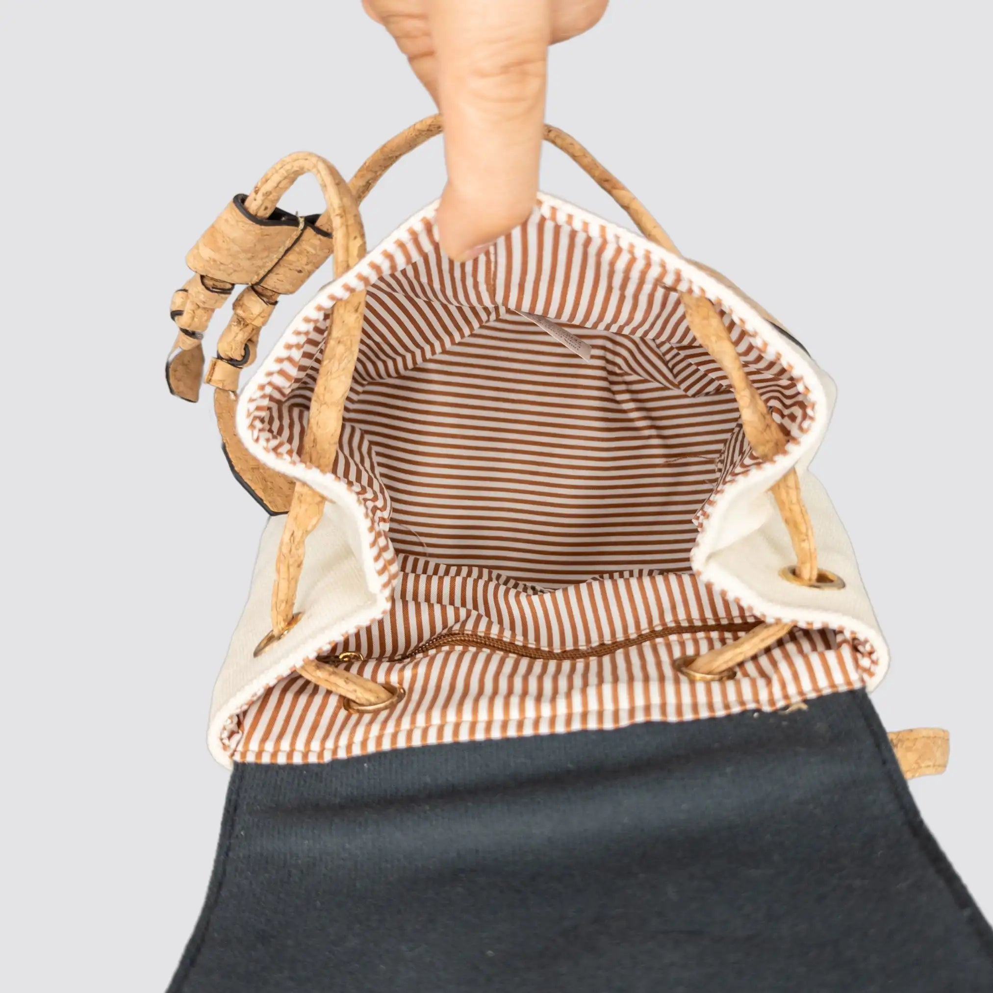Interior view of the White Chic Cork and Cotton Backpack showing the zippered pocket for organization.