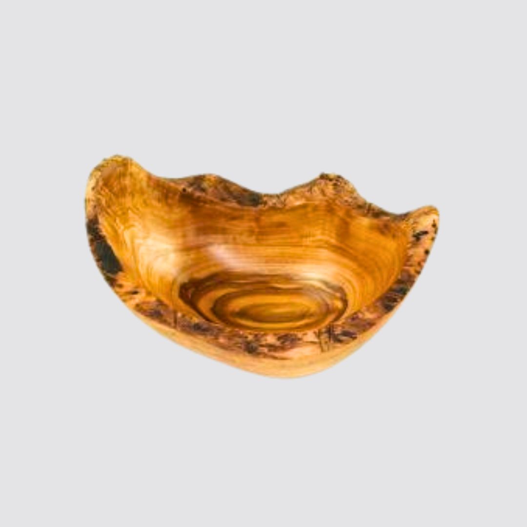 Wooden bowl with natural edge on a light gray background